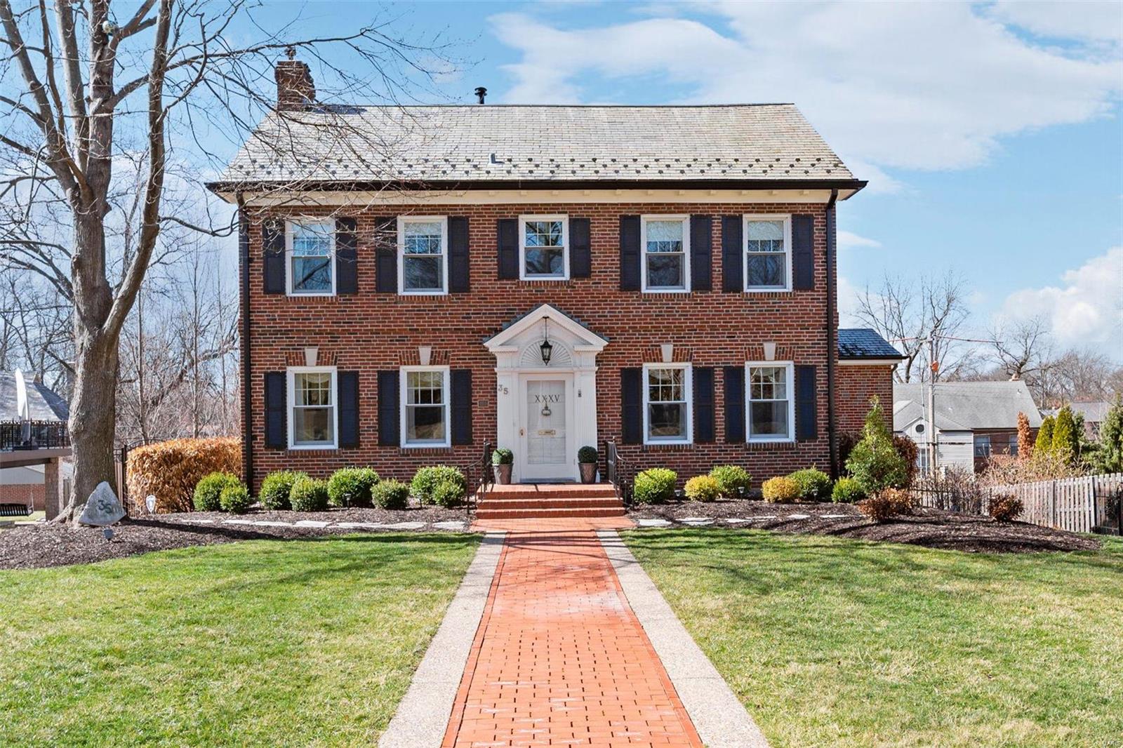 This artfully expanded Claverach Park home is a car lover’s dream with 4 total garage spaces. A substantial 3-story addition includes a spacious family/great rm, huge primary BR suite & 3 more garage spaces. 
The family/great rm has a high ceiling, custom rich paneling, a special Missouri limestone wall with a gas fireplace, walk-in wet bar, casual eating area, built-in shelves & cabinets. Light filled living rm, formal dining rm, big guest bath, kitchen w/white cabinets, main flr laundry combo w/2nd half bath.
The 2nd floor has 4 BR's, 2 full & 1 half bath. Large primary BR has 10’7” coffered ceiling, custom walk-in closet & a 2nd closet, big ensuite bath w/2 sink vanity, tub, separate shower. 2nd BR was originally 2 separate BR's & could be re-divided if want 5 BR's. A full hall bath. Half bath within the smallest BR. 
Professionally landscaped yard w/inground sprinklers, fenced yard, raised brick patio, big back driveway for cars,boat,RV’s, parties & other fun outdoor activities.