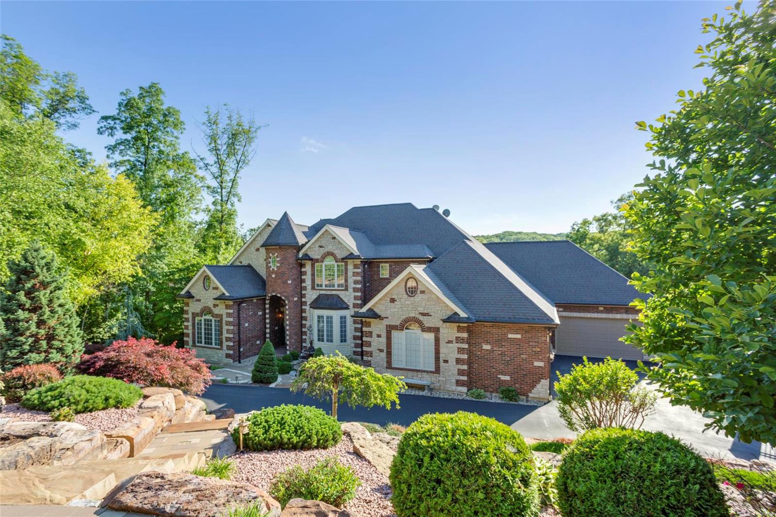 Nestled on 3 wooded acres in a picturesque gated community, this impressive custom-built home boasts over 7500 sqft of luxurious high-end upgrades.  See MLS attachment- too many to list! Just 25 min from downtown and in award-winning Rockwood schools, this stunner is an entertainer's delight! Home features: 3+ bdrms including a private master suite with a gas fireplace and spa bathroom, 4.5 baths, a stunning great room w/sweeping views of the outdoor pool oasis and Paradise Valley Golf Club(18th hole), a gourmet chef’s kitchen, a formal DR with custom inlaid floors, a home theater w/HD Projection, and a home gym with private steam shower and redwood sauna.  Heading outside, welcome to Paradise!  A multi-level composite decking system overlooks a salt-water pool, hot tub, misting palm tree, gas outdoor fireplace, 2 outdoor kitchens, a 90 ft waterfall, and more. Complete w/whole-house technology, 7+ car garage with custom lifts, 600 AMP service with generator, and more- amenities galore!