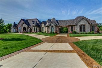 Come and see the finest quality your money can buy! Bax Custom Homes has been building the finest homes in the St. Louis area for 28 years! This home is their own personal masterpiece! Inside & out you will find attention to detail that you will not find in other homes at any price! From the exquisite trim & millwork to the exceptional full masonry exterior of brick & stone, you will find only artisan craftsmanship completed with superior care from top to bottom! Here are just some of the unique features you will enjoy: over 8,300 sq ft of finished living space, 4-bedroom suites, each with private bath, 3 half baths, 5 car garage, plus Porte-Cochere, circle driveway, 10' basement pour, 10' main floor, 8' Bellagio Interior doors, 10' solid mahogany entry door, covered outdoor hearth room, stamped patios, suspended stamped concrete decks w/wrought iron rail, theater w/stadium seating. The list of amenities goes on & on.  Call and schedule your personal tour today!! COOL: 14 SEER+