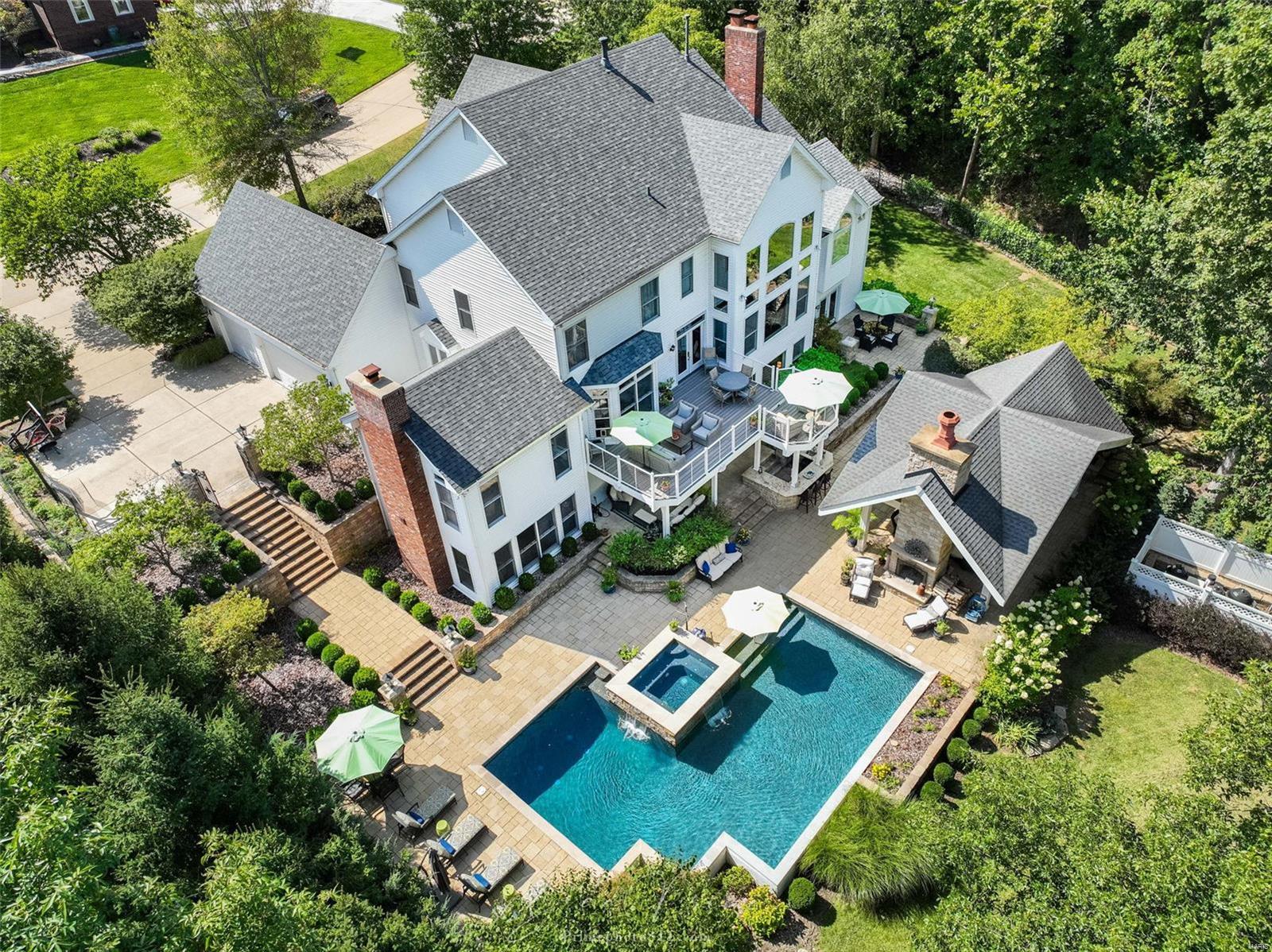 Nestled at the end of this quiet, idyllic street is 13014 Tapawingo Pl,  a beautiful, custom 1.5 story built by Johnson Dev Co. Arguably the best lot on this street, this home sits on an acre, overlooking the Tapawingo National GC. The main floor features a two-story great room w/ a wall of windows; an office w/ vaulted ceilings, gourmet kitchen w/ a hearth room; & a wet bar. You’ll find tasteful millwork throughout the MF, showcasing the craftsmanship of a Johnson Dev. Co build. The master suite is located on the MF, 3 bdrms & 2 full baths on the 2nd fl & an additional bdrm is found in the LL. The walk out LL offers a full bath w/ an additional washer/dryer; a 2nd wet bar & plenty of space for entertainment/play. The dreamy outdoor space is the showstopper! Featuring a full outdoor, covered kitchen; bar, 2 sided stone fireplace; a salt water pool & a spa that can be left open year round. Beyond the pool is an expansive, flat yard meticulously landscaped to provide privacy. Additional Rooms: Mud Room