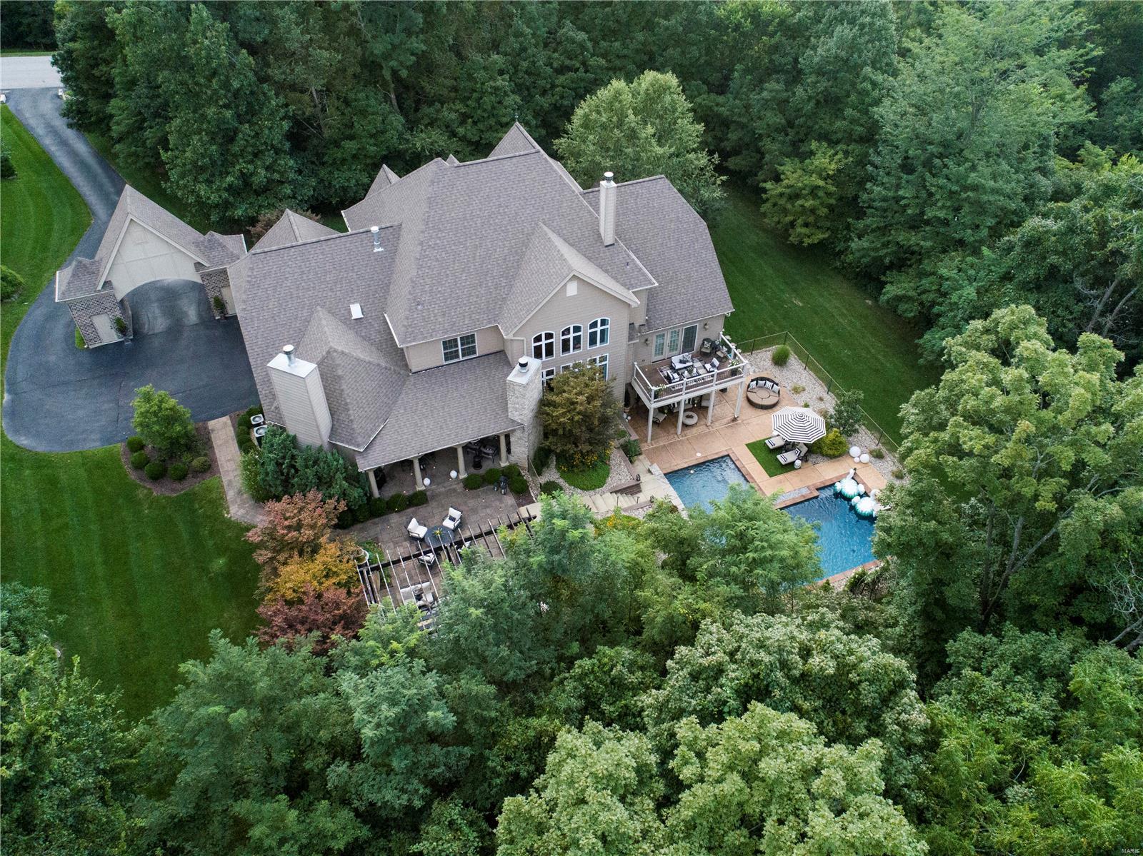 This home will impress your most selective buyer.  Stunning 1. 5 Story custom home with pool & gorgeous views from every window. Surrounded in your own wooded paradise 3.887 Private Acres with deer & wild turkey. Oversized pergola for outside dining with gas fire pit, Covered patio w/ stone fireplace Gorgeous custom designed pool w/ both fire & water features Walk- out main floor level & walk out LL. Second covered patio on LL at pool.  3 car oversized garage w/ carriage way. The interior features 6396 finished sq,.ft. Hearth Room w/ Stone fireplace. Custom kitchen w/ mixed cabinet finishes, triple bullnose granite, center island w/ sink, SS appliances. Oversized dining area w/ french doors to front patio. Hearth room with stone fireplace. Soaring ceilings in great room. Spacious master w/ deck & stunning master bath. Custom millwork in office. Wet Bar in LL. Open Theatre room to rec room. Indoor gym with 12’ ceilings. Building inspection complete & available - Absolutely Perfect Home! Additional Rooms: Mud Room