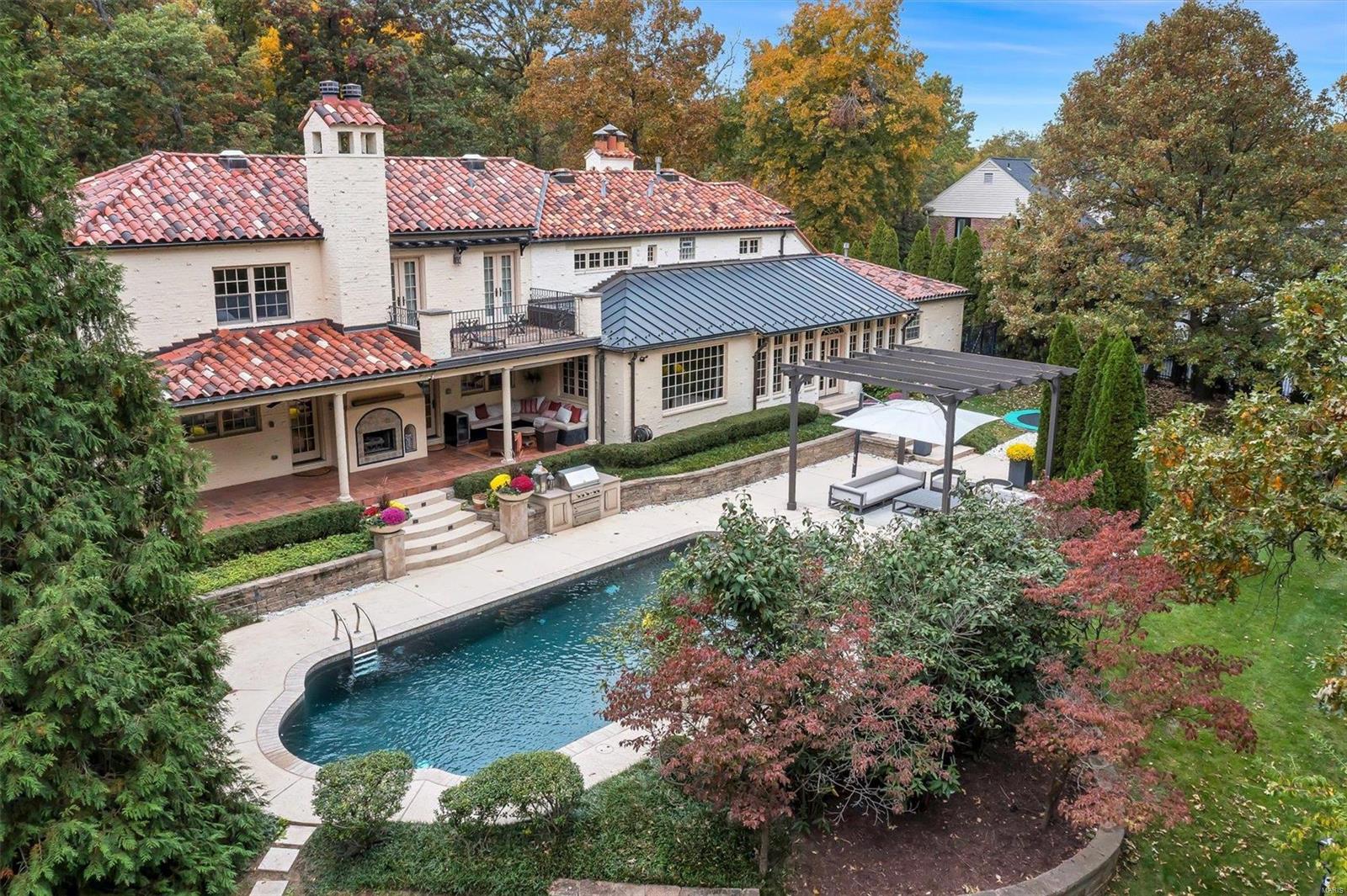 Step into timeless elegance with this Spanish Colonial Revival masterpiece, where old-world charm meets modern luxury. Nestled in a prime Ladue location, this stunning estate boasts a gorgeous main residence with hardwood floors, built-ins, beamed ceilings and multiple fireplaces that exude character. The expanded chef’s kitchen is a showstopper, featuring top-of-the-line appliances, custom cabinetry, and exquisite stone countertops—a dream for both home chefs and entertainers alike. Main floor bedrm suite + 2nd fl primary. Step outside to your resort-style backyard, complete with a sparkling pool, spa, and a covered patio, perfect for al fresco dining or lounging in the shade. Need extra space? The apartment above the carriage house offers the ultimate retreat—kitchenette, family room, full bath and bedrm. This is not just a home; it’s a lifestyle. Luxury, charm, and modern convenience—this beauty has it all! Down the street from JBS, across from S.L.C.C. and short walk to Reed Elem.
