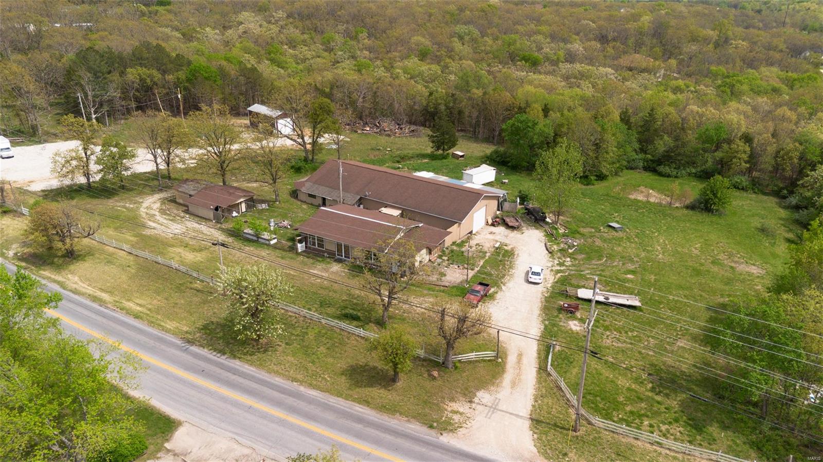 Endless possibilities await with this unique property! Featuring multiple buildings, one with full utilities (water, sewer, electric), you'll find a large garage with an attached 1-bedroom, 1-bathroom home, plus an additional building currently an antique store. Just outside of town, located in a desirable area with no restrictions, this is a fantastic investment opportunity ready for your personal touch. Explore the potential – call us today to see how you can make this property your own! Motivated Seller!