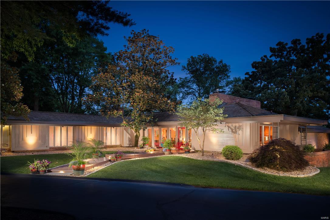 Renovated to perfection, the sophisticated updates to this classic contemporary 5 bedroom, 4.5 bath Bernoudy home enhance this well known architect's original design. Situated to fit the contours of the property on a professionally landscaped 1.26 acre lot featuring extensive gardens, patios and private terraces. Flowing floor plan perfect for everyday living and entertaining - formal Dining Room with vaulted ceiling, steps-down to a large open Living Room with brick fireplace, walls of windows in both rooms create beautiful natural light, private Sitting Room with fireplace and bar is just steps from the Master Suite, Chef's kitchen with top-of-the-line appliances, custom cabinets, breakfast bar and Hearth/Breakfast room open to the back deck and expansive views of the property. The Lower Level has been finished with a bedroom, full bath and family room with built-in bookshelves and cabinetry. This architecturally significant home is conveniently located in Ladue and close to Clayton.