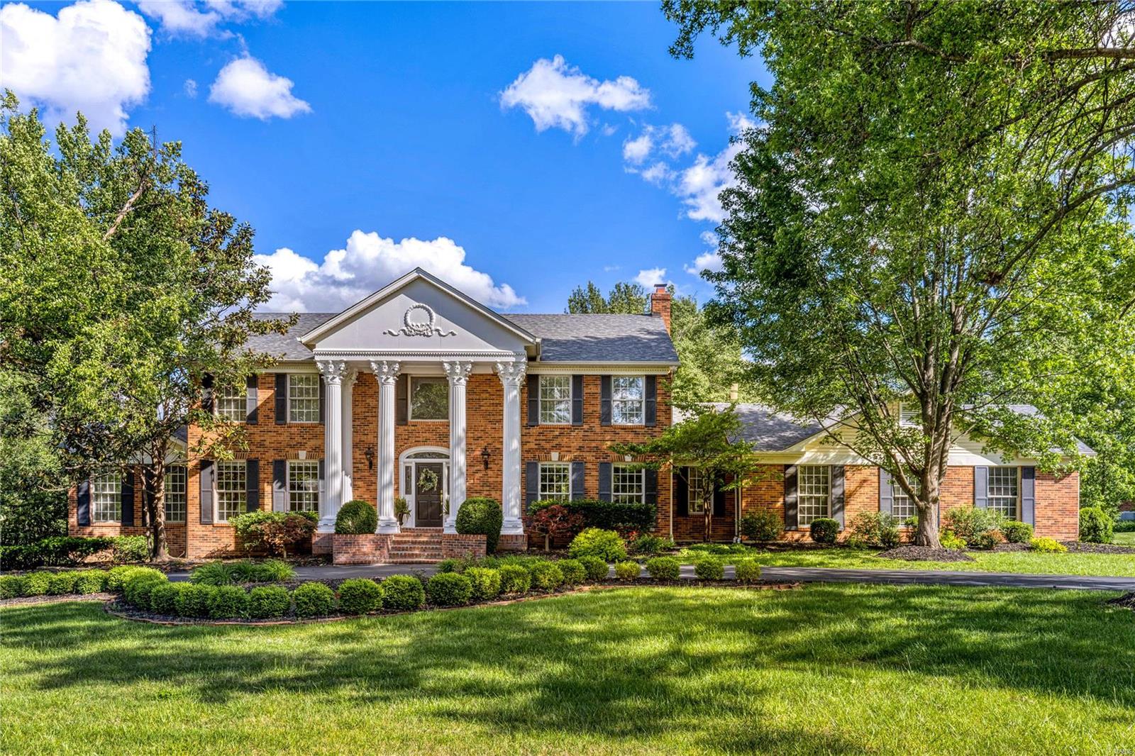 Stately 2-sty Georgian Colonial in premier Town & Country neighborhood. Classic floor plan features well-proportioned rooms with oak hardwoods, detailed trim work & custom built-ins. Impressive 2-sty marble foyer leads to formal living & dining rooms, private study with built-in bookcases & family room with marble fireplace, wet bar & 2 sets of French doors that open to deck. Exceptionally large kitchen with granite countertops, white cabinetry, premium appliances & 7’ center island adjoins breakfast room with convenient planning center. Oak staircase accesses spacious primary bedroom suite with 2 customized walk-in closets & beautifully appointed marble bath w/ barrel vaulted ceiling plus 3 additional bedrooms & stunning hall full bath. Lower Level entertainment space includes recreation room, game room with brick fireplace & wet bar, fitness room, wine cellar & full bath. Situated on parklike 1+ acre grounds with deck, patio, pool & waterfall surrounded by landscaped gardens. Additional Rooms: Wine Cellar