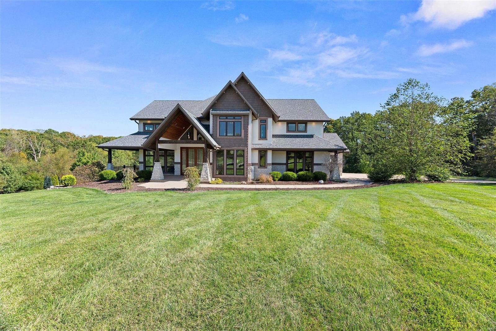 Introducing a luxurious custom 7BR home on 3+ acres backed to woods w/a heated saltwater pool in the sought-after Avondale Estates. This architectural dream home seamlessly blends modern design w/ functional brilliance, creating a space that’s not only visually stunning but also a pleasure to live in. Soaring ceilings, oversized windows, & a generous open floor plan lend to an elegant impression along with high end choices like hand-scraped walnut floors & custom lighting throughout. Impressive chef’s kitchen features shaker cabinets w/ lighting, quartz counters, natural stone backsplash, & SS appliances like double wall ovens & a 5-burner cooktop. It opens up to a vaulted hearth room w/a stone fireplace leading to a composite covered deck overlooking a private oasis. An elevator accesses all 3 floors where you’ll find bedrooms with spa-like ensuites highlighting zero-entry tiled showers w/multiple shower heads. A theater & in-law apartment complete with kitchen occupy the lower level. Some Accessible Features