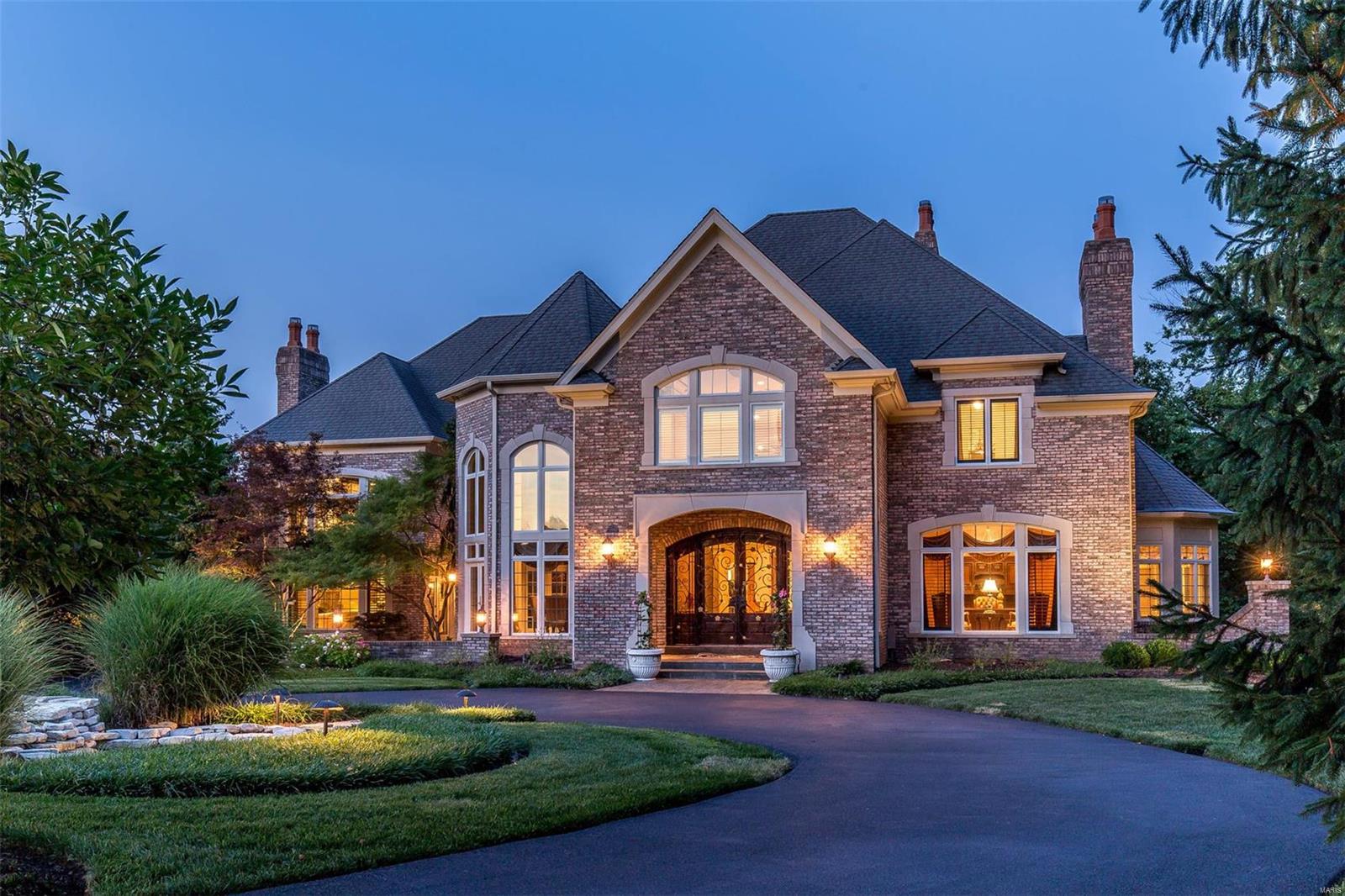 The caliber of the home you deserve. As you enter the gates of Lochinvar you understand that this is a place of seclusion and elegance. The grand foyer's hallmark is a sweeping staircase. The impressive, two-story, light-filled living room features a marble gas fireplace & overlooks the private backyard with salt water pool & hot tub.  The dining room is truly exquisite with a soaring, triple coffered ceiling & French doors leading to a private courtyard. Kitchen with granite counters, custom wood cabinets, breakfast room, & an adjoining hearth room that features a stone fireplace. The main floor master is luxurious with his & her walk-in closets, marble gas fireplace, sitting room, & master bath with Jacuzzi tub.  The second floor features three en-suite bedrooms. The lower level is designed around entertaining with theater room, billiard room, recreation room, wine cellar, wet bar with full kitchen, full spa bath with oversized steam shower, & full walkout with screened in porch.