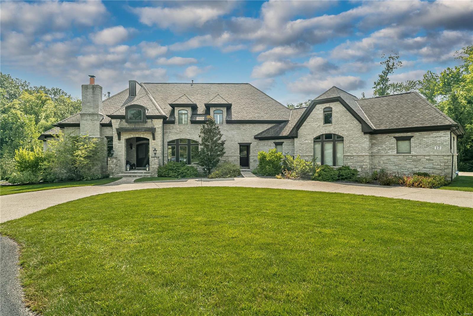 This brick and stone residence epitomizes modern luxury living, blending casual yet elegant spaces with incredible details throughout. Two story entry leads to the handsome wood paneled den with FP, dining room w/Butler's pantry and living room with wall of windows overlooking private yard and pool. Main floor primary suite with fireplace, fabulous bath w/his/her vanities, walk in shower and dual custom closets. The open kitchen with top of the line appliances, 12' island & breakfast room adjoin the hearth room with stone fireplace, built in desk, vaulted ceiling with French doors to the charming screen porch with WB FP. Upstairs are 3 bedrooms, accessible via front/back staircases.Full W/O LL is entertainment heaven with 3D theater, billiard room, walk around bar, family room w/FP, wine cellar, workout room, sauna, full bath and playroom. Stunning pool w/private landscaped yard, 4 car oversized heated garage, mudroom, 2 powder rooms, laundry main and LL, tons of storage. Walk to MICDS Additional Rooms: Mud Room, Wine Cellar