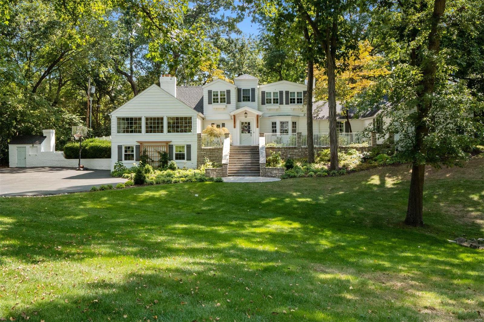 Wonderful buyers placed home under contract after the Open House. Ladue is known for its classic American architecture, and few homes represent this style better than this newest offering. Reminiscent of ocean-front homes in New England or lakeside properties on the Great Lakes, this home blends historic charm perfectly with the needs and desires of the modern homeowner. Six fireplaces accent the stunning formal living room, the large light-filled great room, magazine-worthy kitchen with center island layout, massive primary suite with stylish 5-piece bathroom, secondary suite with a teenager’s dream bathroom and closet, and a finished basement space that provides the perfect hide-away space. Surprising bonus spaces include a den/nursery/4th bedroom with ensuite bath, sizable and level backyard with great privacy and perfect pool/patio site, original smokehouse now serving as a garden shed, and a sprawling front patio/staircase/yard the begs to host a grand event.  Reed Elementary.