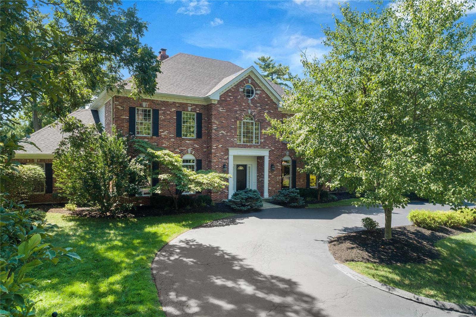 Beautiful Custom built home nestled on 1 acre w/ luxury features and updates throughout. Grand 2 story entry foyer w/ custom curved staircase leading to a radiused balcony over looking the G/R featuring; wet bar, gas FP, & floor to ceiling windows.The gourmet kitchen boasts custom cabinetry, large island w/ seating for 2, granite counters, double dishwashers, butlers & walk in pantries opening to the breakfast area & hearth room. Elegant DR w/ oak wood floors and walnut inlay. Main floor master suite w/ custom his/her walk-in closets, luxury bath w/ Limestone & his/her vanities. Second floor offers 1-bedroom suite & 2 addtl adjoined by Jack & Jill bath. Step down to the walk-out lower level featuring a 12-seat tiered home theater, fitness room, exceptional custom maple wet bar w/ copper ceilings & addtl bedroom suite. Incredible craftsmanship throughout w/ marble & inlaid wood floors, granite counters & elaborate mill work. 2 patios overlooking lush garden, circle drive & 3 car garage.