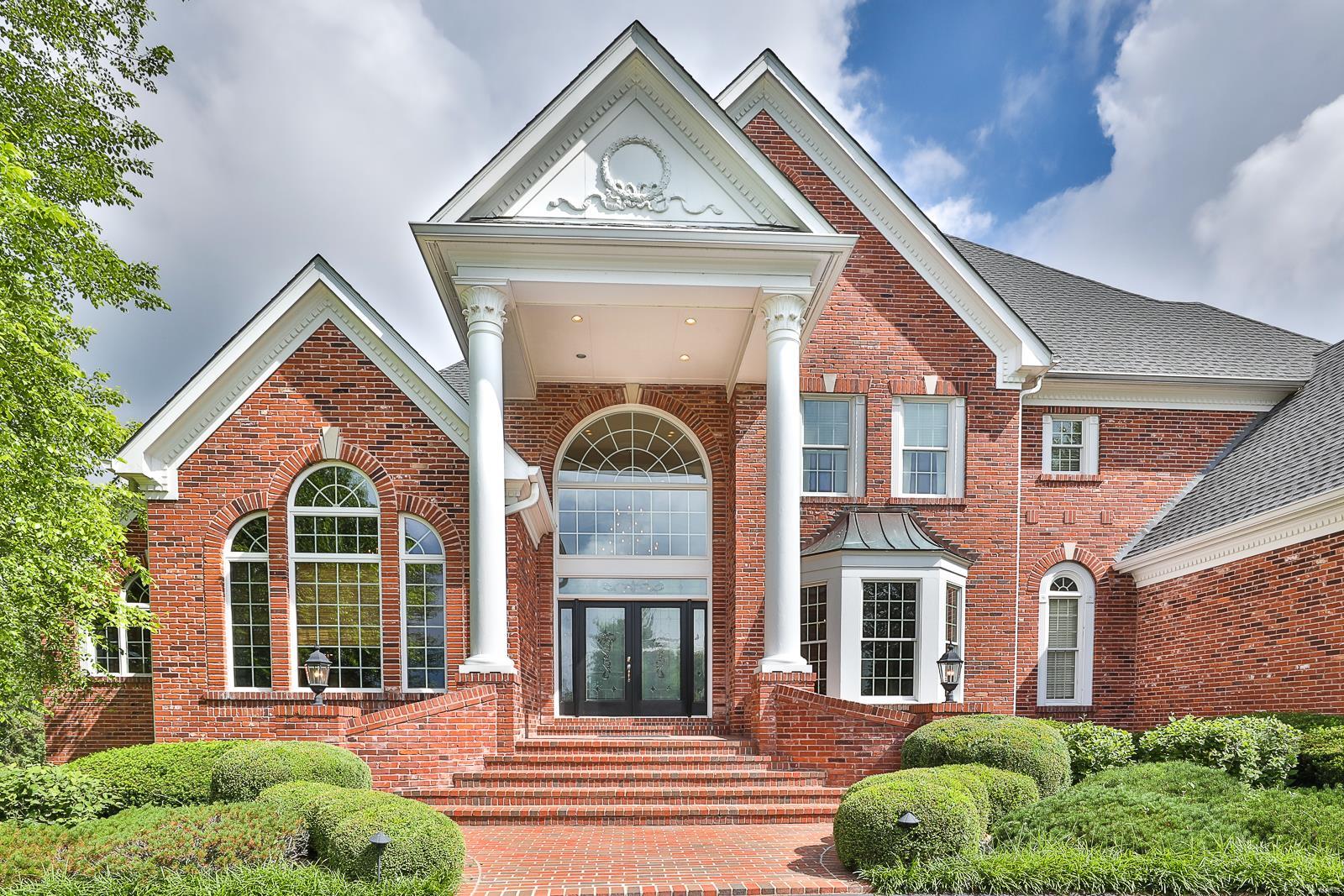 ABSOLUTELY STUNNING 5 Bed 1.5 Story home with inground POOL located on a beautiful & private 1 acre lot scattered w/lovely mature trees. This OUTSTANDING brick home provides in-ground salt water pool, new hot tub, new hardwood flooring, arched doorways, 10' pour in lower level, composite Deck, in-ground sprinkler system, 3 newer zoned HVAC systems, large closets w/organizational systems & so many other updates!  Gorgeous Kitchen boasts custom cabinets w/crown, easy close drawers & pull outs, granite countertops and conveniently adjoins the warm & cozy Hearth Room. Retreat privately into your Main Level Master Suite w/a Sitting Area, built-in shelving & Master Bath. Master Bath has his & her areas, whirlpool tub, separate shower & huge walk-in closet. Each upstairs bedroom has it's own private Bath. Entertain in your Lower Level boasting a Rec Room, Wet Bar, three Bonus Rooms, a Bedroom and a Full Bath w/Dressing Room directly off pool.  Many newer systems & IMMACULATELY maintained! Additional Rooms: Mud Room