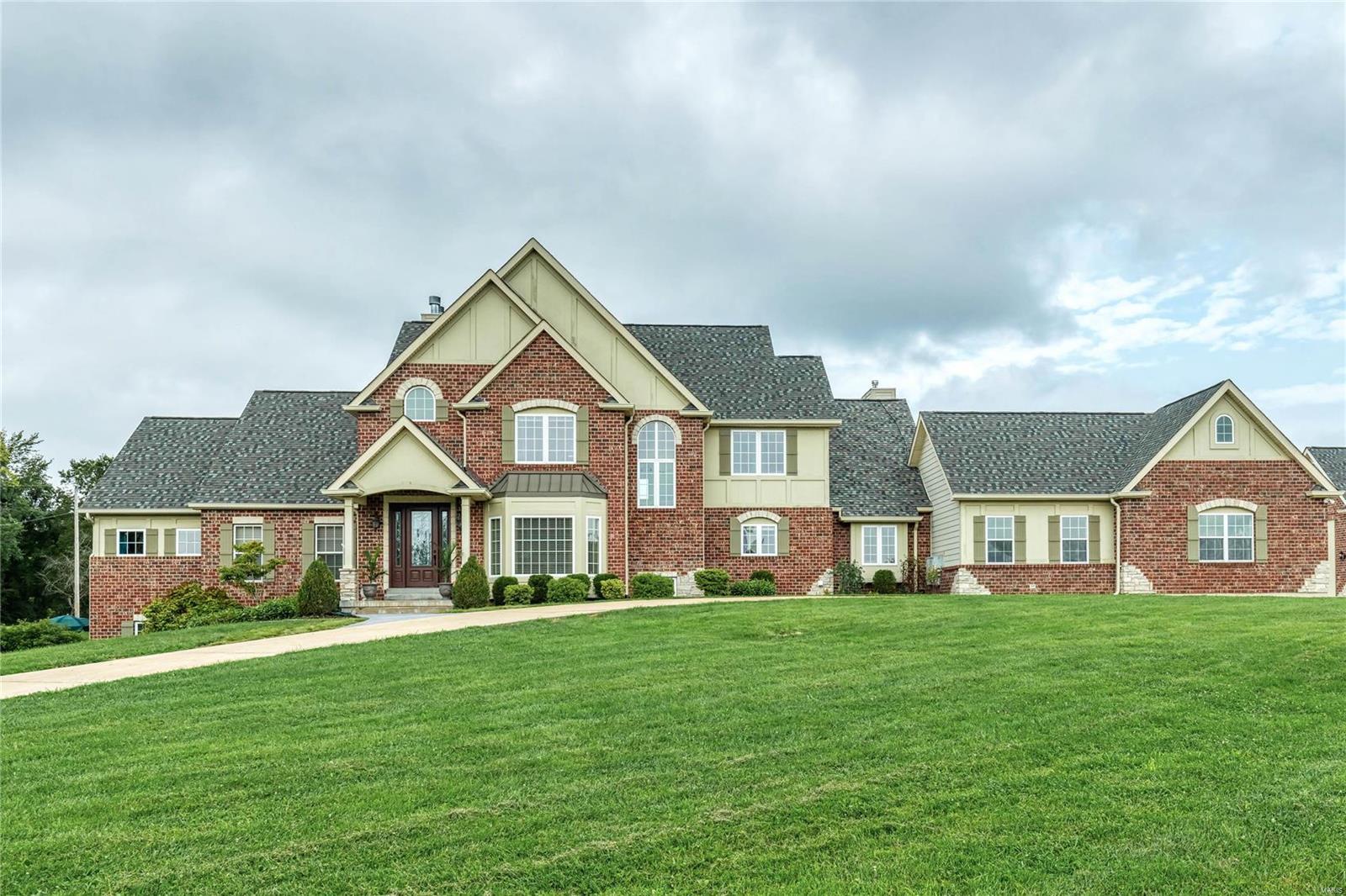 Spectacular Country Estate home on 3-acre grounds! Impressive 2-sty foyer leads to private study w/ built-in work center, formal dining room w/ bay window & stunning great room w/ cast stone fireplace, lighted display cases & dramatic wall of windows. Designer kitchen with granite countertops, cherry cabinetry, premium appliances & butler’s pantry adjoins light-filled breakfast room, vaulted hearth room highlighted by floor-to-ceiling stone fireplace & sunroom that opens to patio. Coffered master bedroom suite combines the enjoyment of a granite fireplace with luxury bath with jetted tub. The 2nd floor extends the living quarters w/ 3 additional bedrooms, 1 with ensuite bath & 2 with Jack n’ Jill bath. Walk-out Lower Level includes recreation room, game room, media area & 2nd kitchen plus workout room, craft room, hobby room & full bath. Situated on an extensively landscaped lot with patio, pool, oversized 3-car garage, auto court, detached garage & 700 sq ft carriage house apartment. Additional Rooms: Mud Room, Sun Room