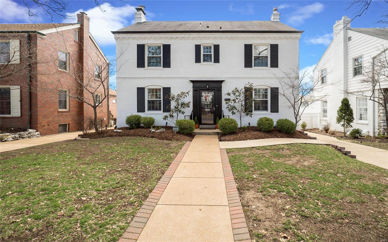 Classic 2-sty Colonial in sought after Clayton Gardens! This spacious brick home offers contemporary amenities throughout while maintaining the charm & character of historic architecture. Gracious hardwood entry foyer leads to formal living room highlighted by marble fireplace, elegant dining room and family room with atrium doors to private deck. Designer kitchen featuring 42” white cabinetry, granite countertops, premium appliances & dining table adjoins convenient butler’s pantry with wet bar. Spectacular master bedroom suite with His & Hers walk-in closets & marble bath with Jacuzzi provides an appealing retreat. 3 Generous-sized additional bedrooms & hall full bath complete the 2nd floor living quarters. Lower Level entertainment space includes recreation room with fireplace, 2nd kitchen & guest suite. Situated on a professionally landscaped lot with fenced backyard, deck & 2-car garage. Within walking distance of St. Louis’ best shops, restaurants & parks.