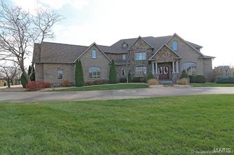 PRICE REDUCED!!
LIVE LIKE ROYALTY IN ROYAL LAKE! This estate has it all! 1.5 story brick/stone home with 7300 SF in sophisticated yet comfortable finished living space on beautiful acreage. Make a grand entrance into this home and feel the easy, open floor plan with high ceilings, crown moldings, wood flooring, and built-ins throughout.  Main level master suite has tray-ed ceiling, huge master closet with custom built-ins, a luxury bath, with custom walk-in shower. Entertain in the spacious kitchen with a center island, large breakfast bar, custom cabinets, walk-in pantry, granite countertops and high end appliances. Includes large main level laundry with custom cabinetry, mudroom with built-in cubbies, and adorable office nook.  Walkout basement is made for entertaining w/large bar, partial kitchen, commercial fridge and subzero wine chiller. Pool and black jack tables negotiable. Walk out to covered patio, outside kitchen, a 20X40 saltwater pool and great 60x80 heated outbuilding!