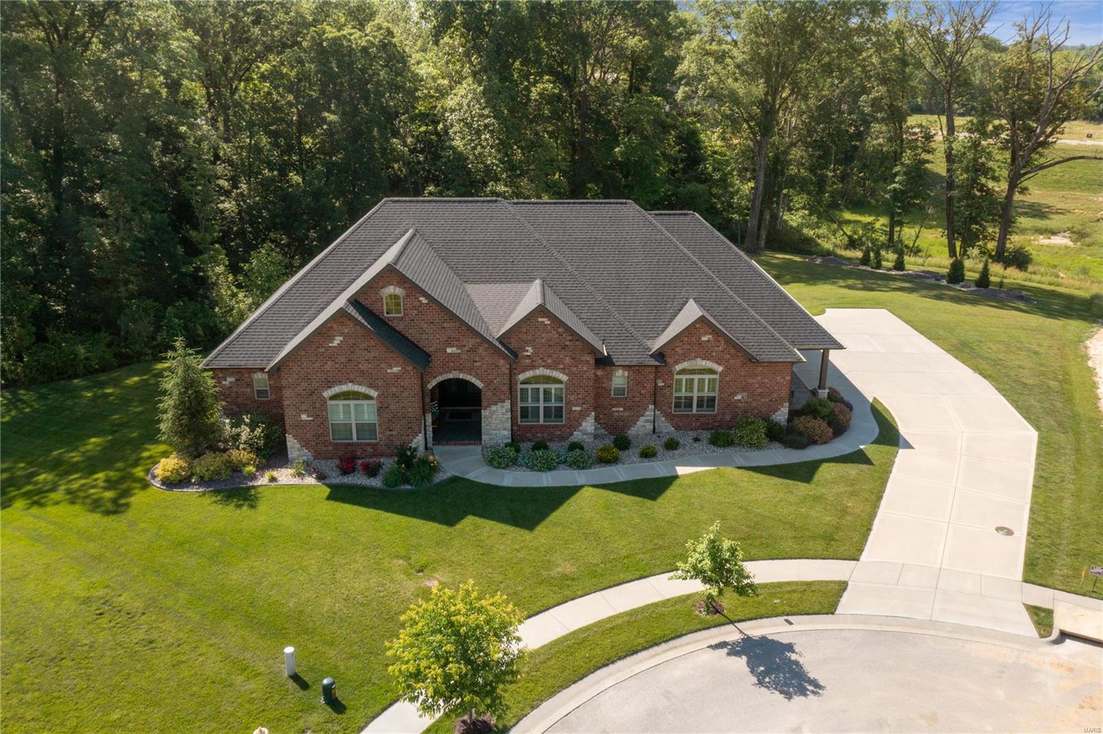 One of the best lots in sought after Bethel Ridge Farms neighborhood! This ranch home sits in a cul de sac wooded lot, on almost 1.5 acres, and has a heated inground POOL! Inside you'll find an open floor plan with beautiful views, gas fireplace and built in shelving, eat in kitchen with a massive island, high end appliances, custom cabinets, and walk in pantry.  There are two primary suites on the main floor on each end of the home.  The main primary bedroom has a separate soaking tub, tiled walk in shower, and an expansive walk in closet. The other primary bedroom has a private 3/4 bath and the 3rd bedroom has access to a full bath. The laundry room is also on the main floor. The finished walk out basement has a family room with gas fireplace, rec area, and a custom bar with copper countertop, dishwasher, and bar refrigerator. Bedrooms 4 and 5 in the basement share a full bath. There is also a large basement garage. Irrigation system, geothermal, generator hook up, and so much more!