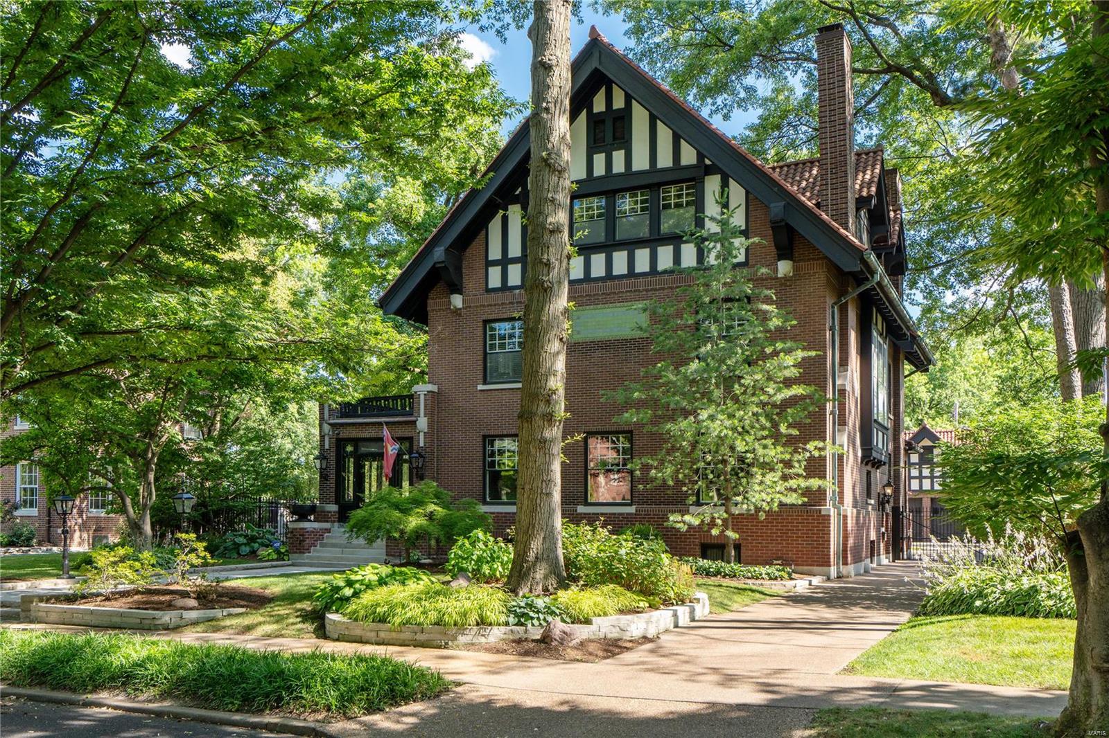 Located in storied Parkview, this Harry Clymer designed home was built for Charles H. Peters, founder of Lindell Trust.  Upon entering the grand center hall foyer, you are greeted with original wood floors, moldings, paneling and staircase with a beautiful stained-glass window.  With large rooms, a circular flow and multiple access points to the gardens, this home was designed with entertaining in mind.  The 2nd floor hosts a large primary suite with custom wardrobes, a spa like bath finished in Carrara marble, fitted with steam shower, soaking tub, heated floors, 2 vanities and windows with 3 exposures of natural light.  Three additional bedrooms, a full bath and laundry complete the 2nd floor.  The 3rd floor has 2 additional bedrooms and large media/family room.  The fully fenced oversized yard contains multiple entertaining spaces and access to 3-car carriage house with finished flex space and ½ bath.  Lovingly preserved, this home is truly a St Louis architectural masterpiece.