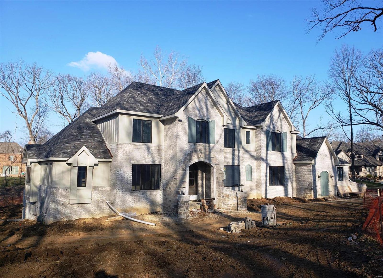 Nearing Completion. Photos coming soon. Flower Homes introduces the 2019 Hickory Plan featuring a dramatic and uniquely-styled bright and open floor plan. The heart of the home “Gathering Room” hosts the Custom Kitchen, Breakfast Room and Hearth Room under vaulted beamed ceilings and centered by a stone/brick fireplace flanked by bookcases. Two bedrooms are on the first floor, the Luxurious coffered Master Suite and a Guest Suite. Double beveled glass mahogany front doors open on a coffered foyer flanked by the dining rm and the living rm/study with pocket doors. Off the Gathering Rm, the 15’ x 31’ patio offers plenty of outdoor entertainment area in the wooded private back yard suitable for a pool. The lower level finishes include a 6th bed and bath suite, recreation rm, game rm, wet bar and walk-out to back yard. This home is loaded with upscale appointments and features.  Come see and enjoy.