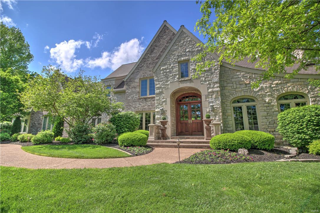 WOW, $100,000 PRICE REDUCTION! Spectacular custom built Johnson home w/exquisite architectural detail & exceptional craftsmanship. Designed for endless entertaining opportunities & extraordinary luxury living. Enter the dramatic 2 story entry w/Barrel vault ceiling & note the gorgeous marble floors & richly appointed wood paneled Study w/ FP. The 2 story Great Room features a wall of windows, providing dramatic views of the grounds. The Gourmet Kitchen has it all, w/huge center island, and flows into Hearth Room w/Stone FP. Main floor Master Suite is a private oasis w/sitting area & spa inspired bath, w/heated floors & steam shower. High level finishes throughout, including the expansive walkout LL, Featuring a large Fam room w/custom bar that seats 12, Guest B /R w/full bath, Media Room, Gym, & Game Room! Located on a park-like 1.77 acre lot in LADUE SCHOOLS, the manicured lawns are complimented by Lush landscaping, & a fabulous patio w/built in gas fire pit overlooking the Pool area.