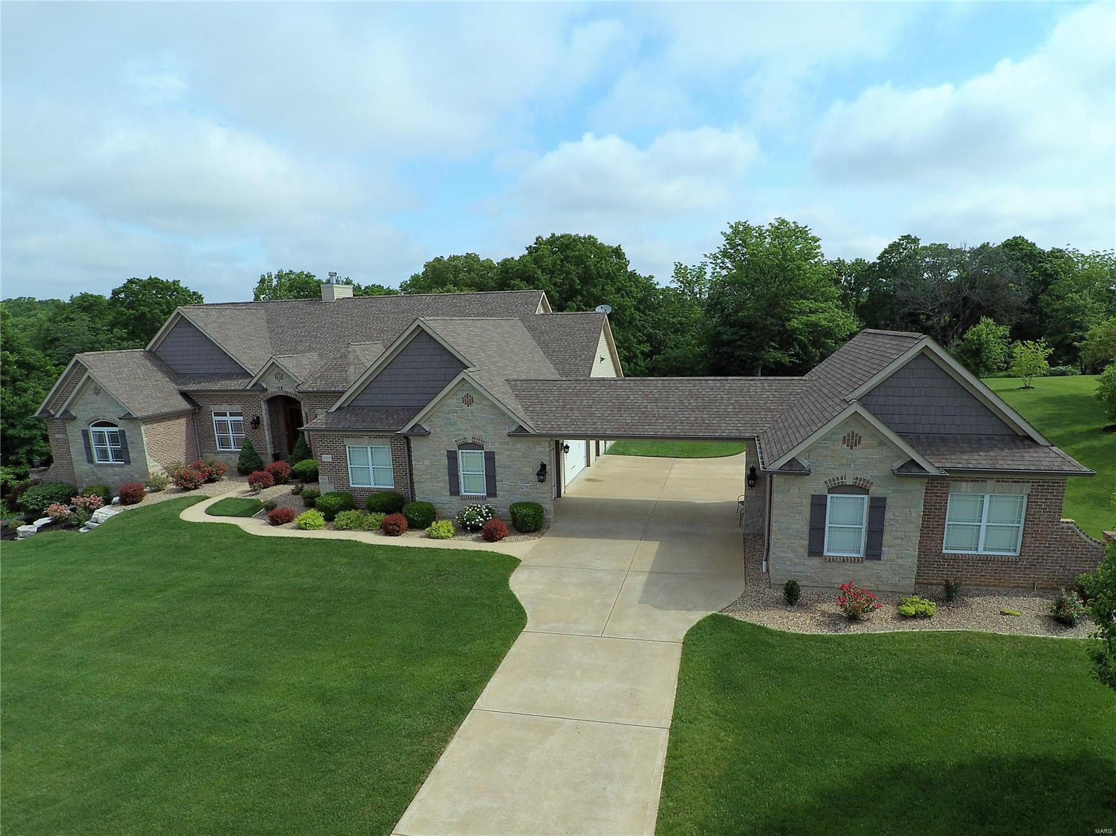The home you have only dreamed about and it is only 3 minutes off I-64 is waiting for you! The home exudes warmth, charm and quality at every turn. The floorplan has been thoughtfully designed for family lifestyles and entertainment. The estate features a great room with soaring ceilings, rich wood floors, a professional, showroom-quality chef’s kitchen and warm hearth room. Serene and spacious, the master suite includes a luxurious bath and two walk-in closets. The lower level is free flowing with large entertaining spaces, a custom bar and an additional laundry. A resort-like backyard invites private relaxation and recreation with a sparkling pool, expansive lawn, large patios, outdoor living room with fireplace and outdoor kitchen. COOL: 14 SEER+