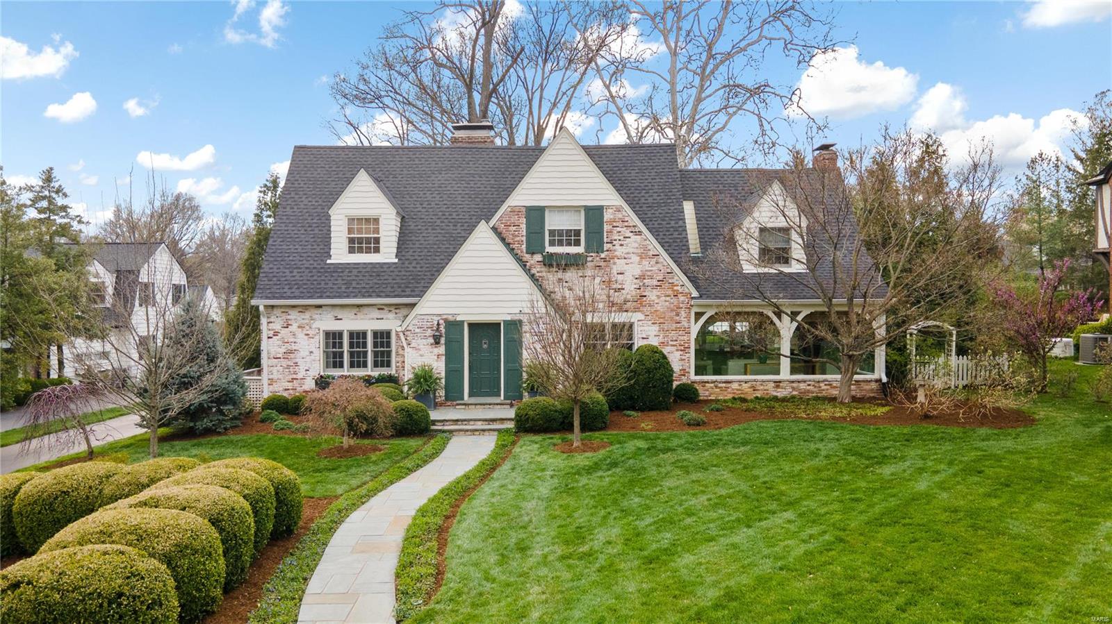 Nestled in the heart of Ladue, this enchanting cottage-style home is within walking distance of Clayton restaurants and shops. Enter timeless elegance and gracefully move to the heart of the home—the kitchen/family room—collectively designed for casual family gatherings and heartwarming good times. French doors open wide so guests flow freely to the patio for starlit entertaining. Every space reveals a story of classic style, tasteful renovation, reflecting the home’s rich history and livable lifestyle. Enjoy the comfort of newer systems and exciting amenities, 2-car garage, and easy parking for guests and family alike. Second floor boasts a great layout with kids enjoying their own hang-out space and parents with primary designed for privacy and relaxation. But, the charm doesn't end there - tucked away in the landscaping and trees is a delightful garden cottage offering a secluded retreat for a calm or creative getaway. Welcome home to your dream come true. 8 minutes to the airport