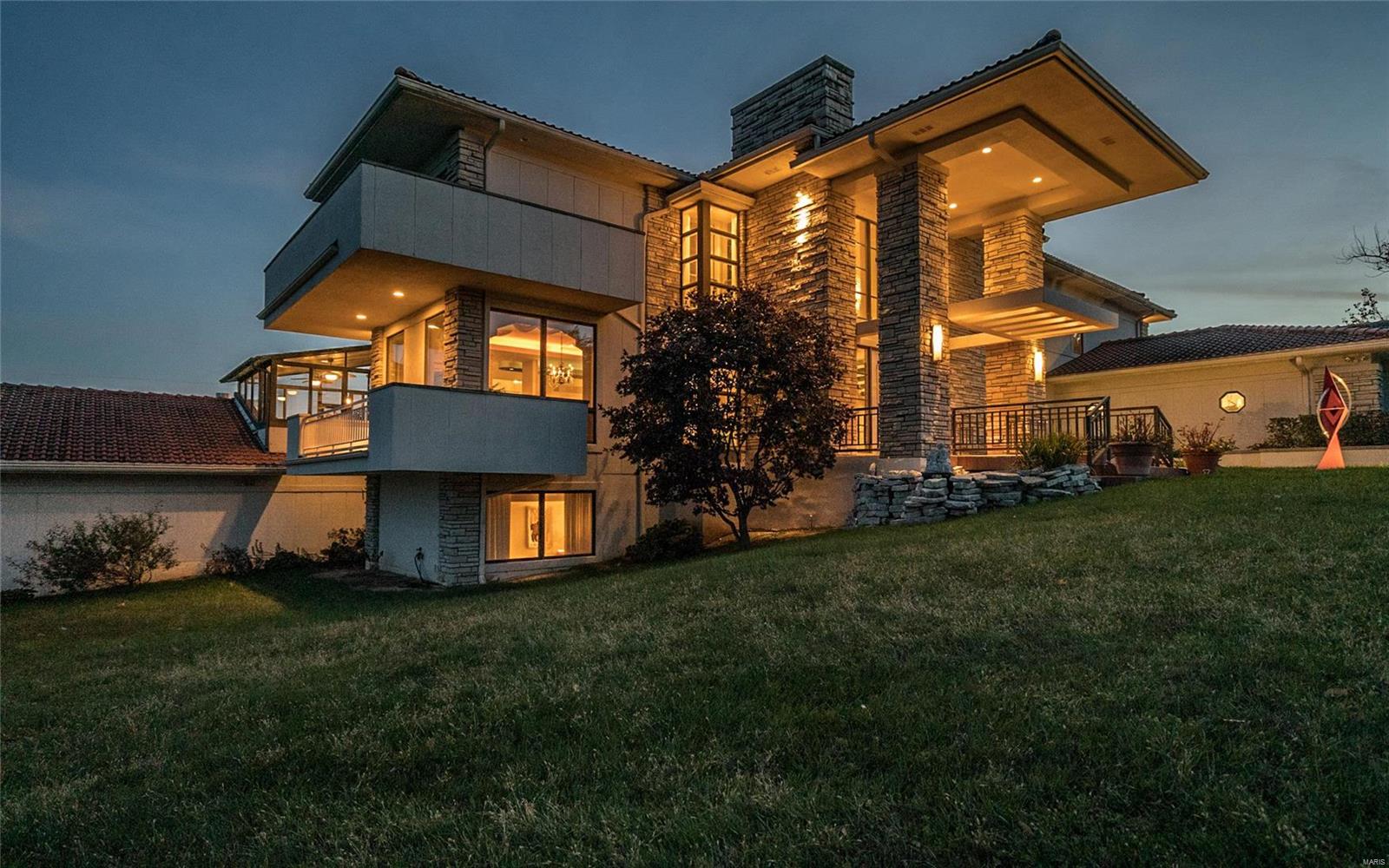 PRICED TO SELL! One of the most substantial homes you can buy under $2,000,000!  This legendary significant landmark provides an opportunity to acquire one of Creve Coeur’s largest & most exclusive properties. Stunning breathtaking views of the ~26 acre lake from all 3 levels of the home ~6.9 acres of adjoining common ground/tennis court. 6 total bedrooms, total 6 full& two 1/2 baths, ~8496 sq ft. Sumptuous appointments: expansive walls of glass flood nearly every room with natural light, 2 story great room, marvelous bedrooms-retreat-like master suite with stone fireplace/office-study & balcony, downstairs recreation room/fitness center & ~1800 bottle wine cellar/bank vault. The centerpiece is a~1728 sq ft-indoor resort style pool, waterfall, fountains & spa. 5 car heated garage. 1 acre lot, stone interior walls & fireplaces-2 stone+1 marble, marble floors, elevator, terraces/balconies, au pair suite/ kitchen, enclosed porch, huge paver driveway, fish pond, magnificent clay tile roof. Additional Rooms: Wine Cellar