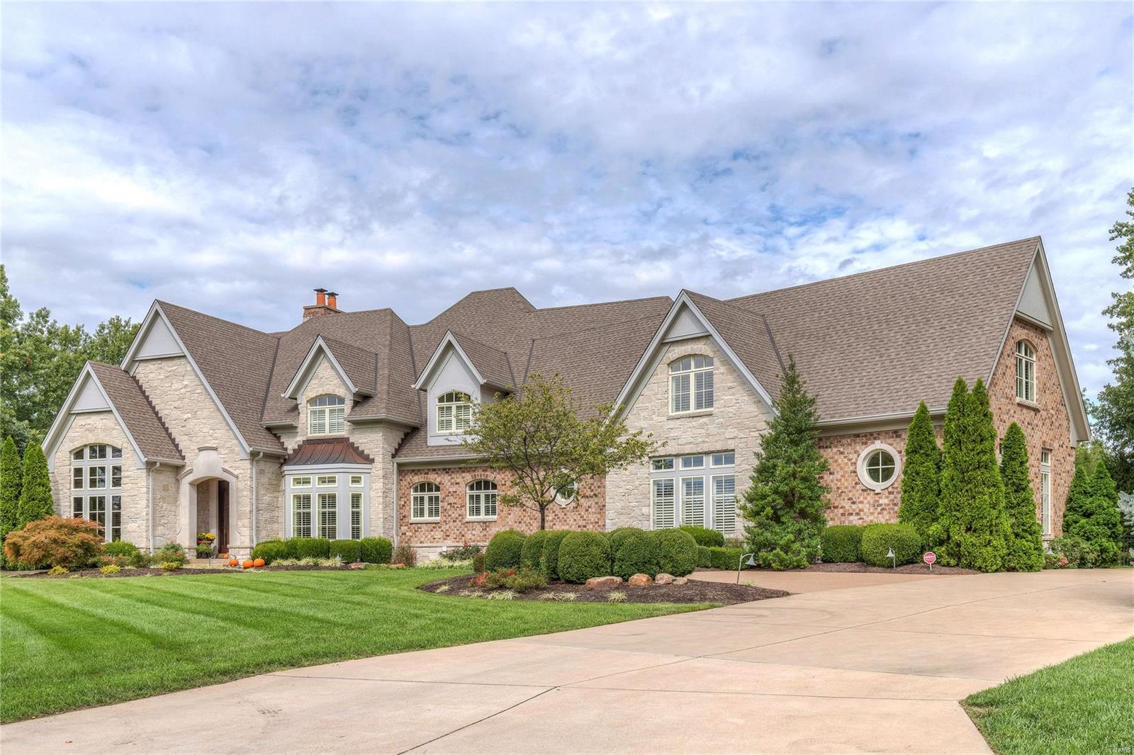 Exquisite 1.5-sty Estate home inspired by classic European architecture! Over 9800 sf of living space enhanced by soaring ceilings, elaborate millwork & wide plank flooring throughout the main living area. Dramatic marble foyer leads to handsome study with leaded glass doors, custom built-ins & wet bar, elegant dining room and spectacular great room with marble fireplace, wide bow window & gathering bar. Chef’s kitchen with glazed cabinetry, Dacor appliances & butler’s pantry adjoins breakfast room with built-in china cabinets & hearth room highlighted by floor-to-ceiling stone fireplace. Coffered master bedroom suite features beautifully appointed bath with Jacuzzi & sitting room. Flared hardwood staircase accesses 3 additional ensuite bedrooms, bonus room & laundry. Lower Level includes recreation room with see-through fireplace & cherry wet bar, media room, game room & billiard room. Impeccably landscaped grounds with covered patio, outdoor kitchen, bocce court, pool & 4-car garage.