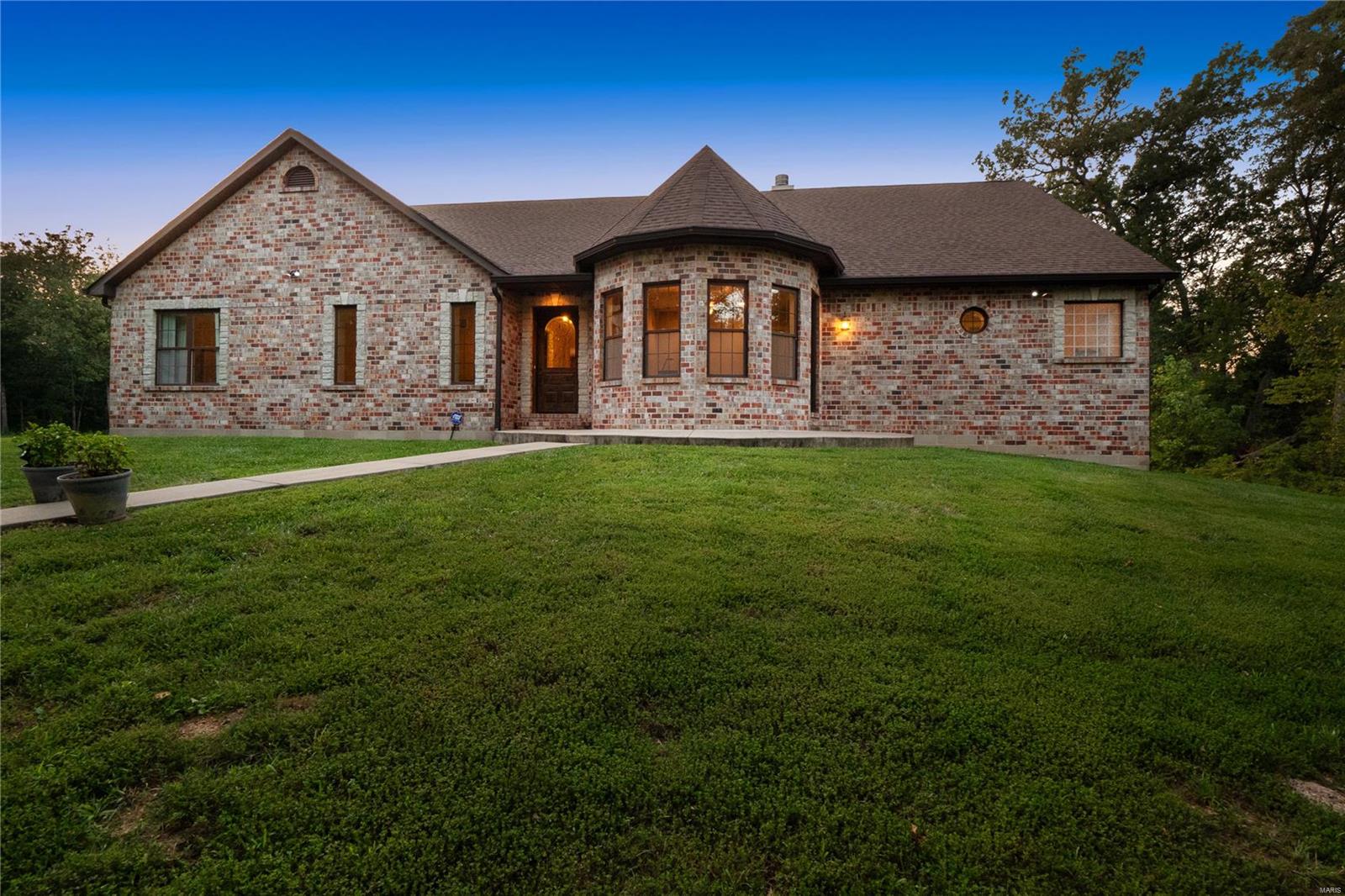 Discover 30 Hoffman Hills nestled on 5.73 acres, this 4bed + 4.5bath home is a perfect blend of seclusion and access to modern conveniences. Meticulously designed, the custom floor plan with 3-car side entry garage AND partially finished walk-out lower level invites you to multiple living spaces. The Great Room is highlighted by a vaulted ceiling, stone fireplace and window wall over the wooded lot. The Chef’s Kitchen includes custom cabinets, center island, GE Profile appliances. The Dining Room is enhanced by a brick fireplace. Outdoor enthusiasts will love the decks, patios, gazebo and fireplace in a natural setting. The property includes 2 versatile buildings, 30x30 + 48x46 equipped w/ 2 bathrooms, O/H door and shelves. These structures can be tailored for a workshop, vehicle storage or studio. The timeless selections, fixtures and custom cabinets pair well with rustic finishes. Quality constructed; Geothermal + ICF foundation. Conveniently located to wineries, shopping and dining. Additional Rooms: Mud Room