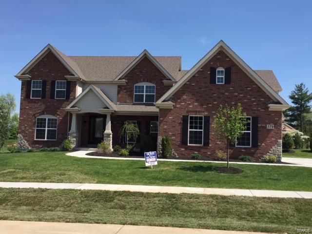Beautiful and Stately 1.5 story New Home on a 3/4 acre homesite in the highly desired Belle Maison community is READY NOW. This fantastic central location with mature trees and a lake gives you easy access to 270 and Hwy 40. This beautiful home features:  Very open floor plan with a huge Gourmet kitchen w/ custom cabinets, large granite Island, desk,  custom pulls, Hearth Rm with stone front fireplace & vaulted ceiling, 2-story Great Rm, Expansive laundry w/ cabinets, Large concrete patio, 24 x 24 game rm w/ balcony, 3 piece crown molding at foyer, Great Rm and upstairs Hallway. Sculptured ceiling and chair rail w/ wainscoting in dining room, 3 car side-entry garage. Spacious 1st floor Luxury Master Bathroom suite. 4 Bedroom 3.5 bath, jack & Jill bath plus much more!  9Ft Ceilings on the First Floor, Gas Fireplace in Family Room, Riverwood Staircase with Iron Balusters,  30 Year Architectural Shingles.