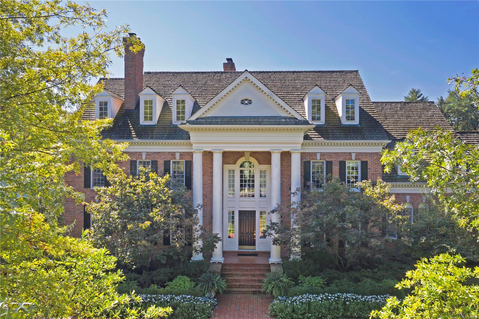 Magnificent Georgian residence situated in St. Louis Country Club Grounds! This palatial 6+ bedroom home designed by Marshall Watson NYC is the ultimate in luxury, privacy, and gracious living. The 2-story entry is dramatic, with it’s sweeping staircase, fabric walls and painted ceiling. Architectural details include painted murals, vaulted ceilings, extensive millwork and archways. Top-of-the-line kitchen opens to a custom bar, dining space, and hearth room with vaulted ceiling and oculus. The living room, den and dining areas are resplendent in their decor. A hand painted mural graces the master suite walls. There is a large sitting room with fireplace and luxurious bath with jetted tub and marble finishes.  Lower level with full kitchen, media/game room and guest quarters. 2 porches and lovely patios overlook the lush grounds, sparkling pebble-tec pool and fountain. First floor laundry room, 4-car garage, 1.95 acre lot. Elegance defined! Additional Rooms: Mud Room
