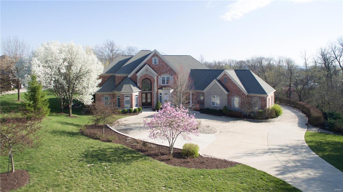 New Price and newly stained hardwood floors! Live in desirable Windcastle Subdivision! Four sided, oversized brick home w/stone accents, 4 car garage on 2 private + acres w/beautiful pool, fire pit, play area, deck & patio. Marble entry flows into a 2 story, wall of windows overlooking the back yard. Completely remodeled kitchen w/custom cabinetry, stainless steel appliances, granite counters w/custom granite, 4 gas burner oven w/grill and griddle. Cozy hearth room just off kitchen w/fireplace for cool nights & overlooking the pool for hot summers. Main Floor Bedroom boasts a sitting area & beautiful Master Bathroom w/a jet tub, separate shower & a changing room/closet. Second Floor master has a fireplace, sitting area & newly designed Master Bath w/soaking tub & zero entry custom built shower. 2nd floor also has laundry area. Lower level has a fabulous theater room, custom bar w/fabulous mosaic tiles, bedroom, 2 full baths, exercise/play rm & a 1000 bottle wine cellar & tasting room.