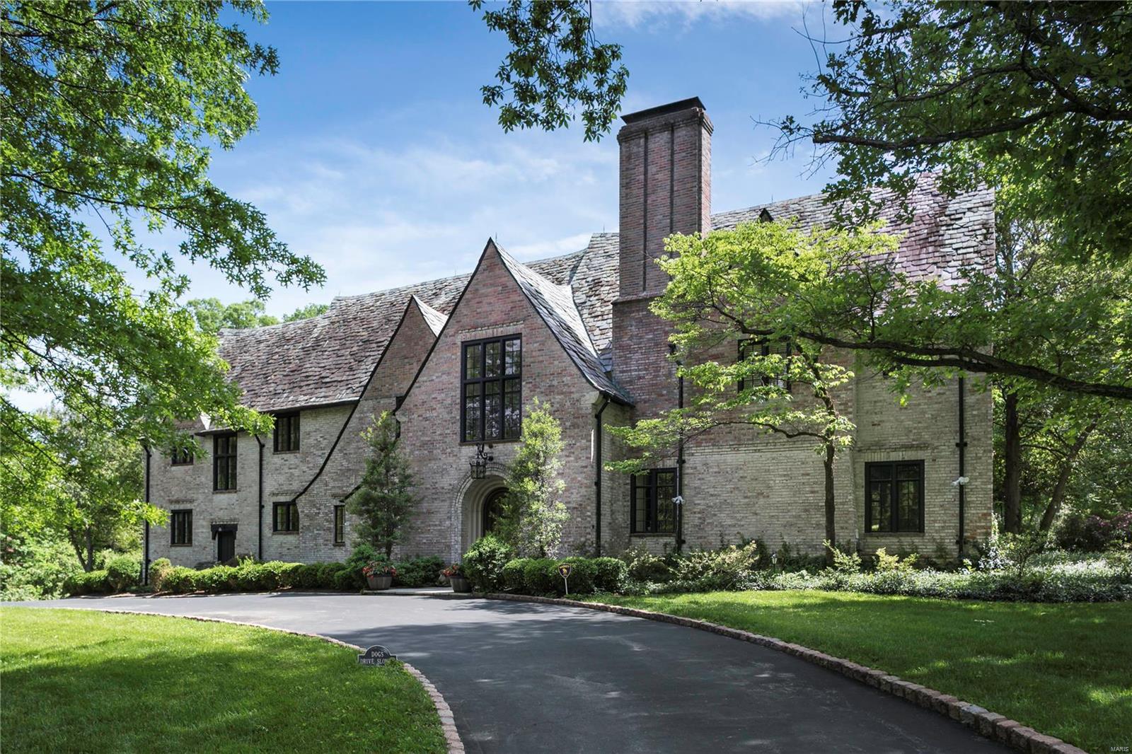 Enchanting Maritz & Young English Tudor situated on 2.5 breathtaking acres in the heart of Ladue.  Architectural details including slate roofing, herring bone floors, hand hewn beamed ceilings, beautiful raised panel woodwork, arched ceilings and doorways, and custom wooden doors unite to create a spectacular residence with warm, inviting spaces that make this house extra special.  The grand living room and wood paneled library open to a gorgeous, brick terrace with a fountain that overlooks the park-like grounds that include a tennis court.  The newer chef's kitchen and hearth room with custom white cabinetry and marble counter tops has a Subzero refrigerator, Miele dishwasher and Thermador 5 burner cook top, built in ovens and warming drawer. There are 2 small bedrooms and a bath off of the kitchen.  Upstairs, there are 5 additional bedrooms and 4 bathrooms.   This house and property offers an exceptional opportunity to live in one of the finest neighborhoods in St. Louis.