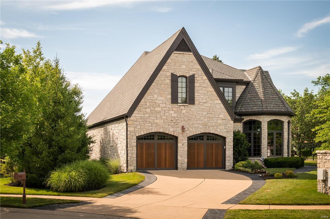Welcome to maintenance free Villa living! Villa life means virtually no yard work & most exterior repairs covered, including roof. This meticulously maintained villa is the only stand alone home in a secure, gated community. Stately features include stone construction, arched doors & windows, vaulted ceiling, wood floors, recessed lights, inviting gas fireplaces, & elegant custom millwork. Enjoy the convenience of attached 2 car garage, elevator, spacious storage, zoned audio, & a main level w/ laundry, professional den/office, 1/2 bath, & master suite w/ large walk in closet & jacuzzi tub. Upper level w/ office & entertainment area & 2 bdrm suites w/ walk in closets. Kitchen has custom granite, double oven, Wolf gas range, Subzero fridge, & Alspaugh custom cabinetry. Lower level w/ bdrm suite, sauna shower, game rm area, entertainment center, & custom wet bar. Unwind in the hot tub after entertaining on 2-level porch w/ gas hookup. Ideally located by Chesterfield Pkway, 141, & 40/64.
