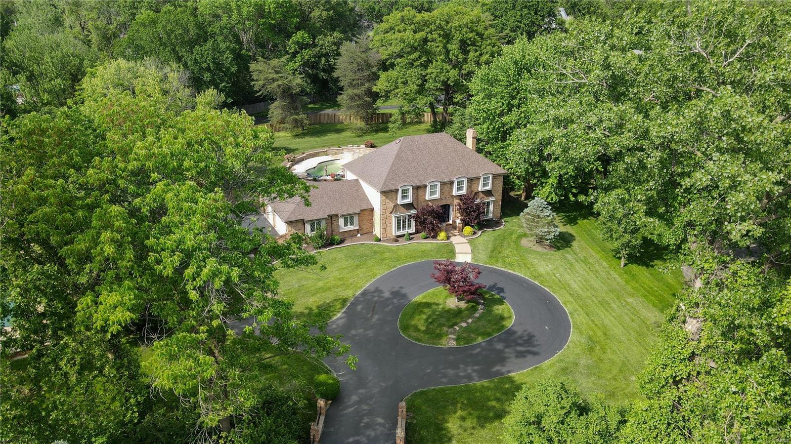 Welcome home to 6 Clayton Hills in Town and Country where your lovely, updated brick beauty sits on over 1 acre with a circle drive and an INGROUND POOL with pool house style sunroom addition (granite wet bar with wine cooler and built-in ice maker) to accommodate the indoor/outdoor entertainment factor! This 5 bed 4.5 bath home is bright and open with a giant kitchen that includes beautiful custom cabinets, granite tops, and SS appliances (double wall oven, electric cooktop, microwave, dishwasher and custom fridge). The finished basement just adds to the amazing living space in this home. This is priced to move and centrally located (within 20 minutes of everything)!  Make your appointment today! Additional Rooms: Sun Room