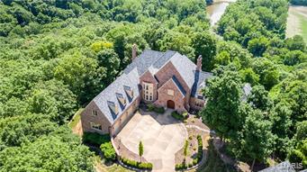 Remarkable estate w/outstanding $400,000 price adjustment, along w/fresh paint, wallpaper & outdated window treatments removed. Beautifully staged & seller is eager for a contract! Located on a Bluff lot on the gated Wings Rd within St. Albans Country Club w/amazing views for miles. The main house is a 1.5 sty with 4+beds & 6 full/2 half baths, finished walk out lower level yard w/lovely in ground pool. 2-story great room, paneled library, huge kitchen/hearth room, dream master suite w/sitting area, his & her customized closets & glamour bath. Upstairs 3 large beds each w/own bath plus  2nd floor family rm. The LL has a lge family rm w/lge customized wet bar w/built ins, 2nd kitchen, media rm & possible additionaled rs w/full bath. The detached carriage house w/ 2nd-flr guest quarters w/family room, bedroom, full bath & kitchen area. (Bath & kitchen have to be finished out but all the plumbing is in. New windows & roof recently installed. Simply breathtaking.