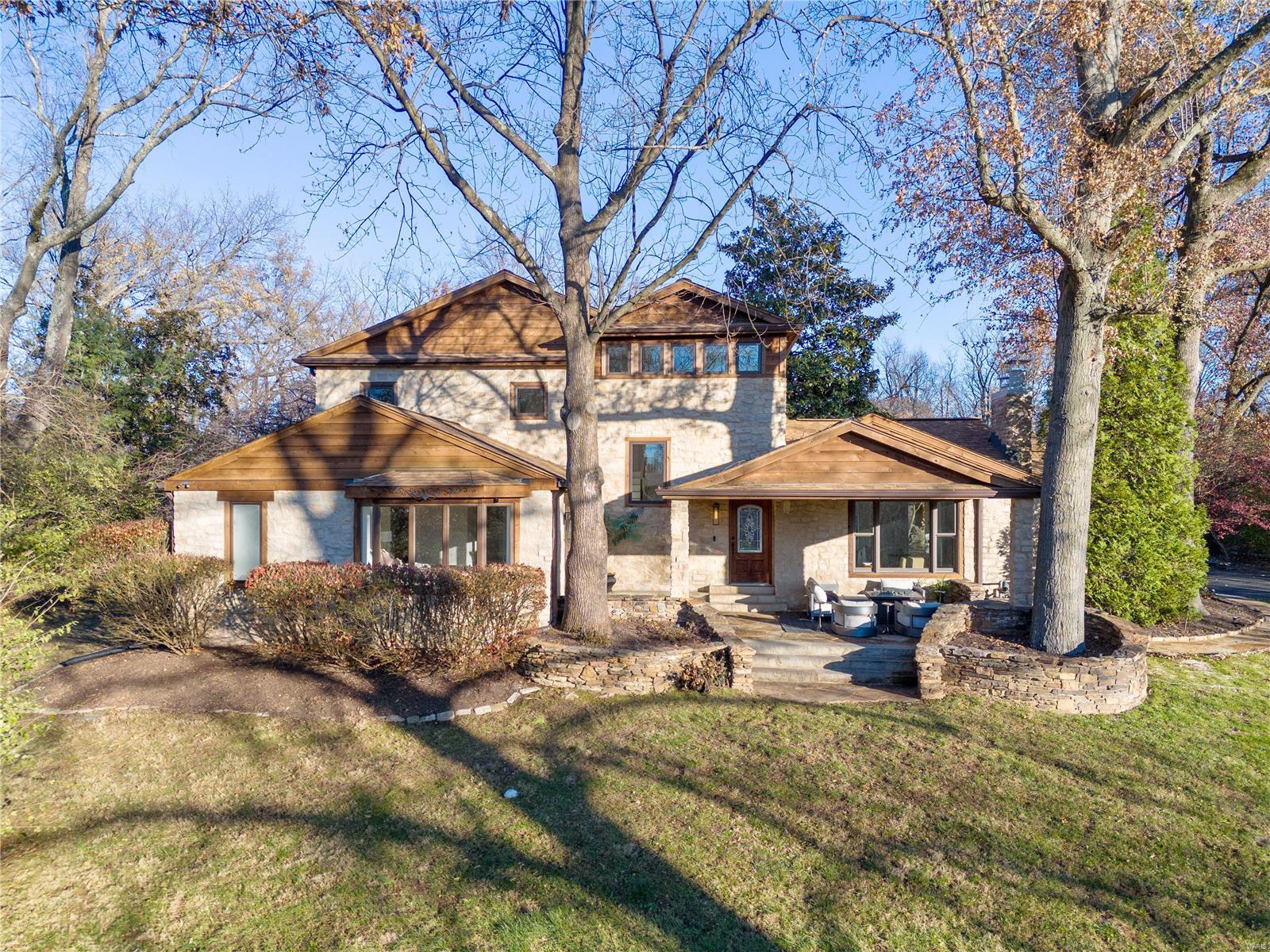 This stunning estate is situated on 1.75acres with many renovations and special features! Every detail is meticulously crafted for sophisticated living. Perched high at the end of a long private lane, the rustic exterior welcomes you to a front porch seating area that opens to a completely modern renovation. Striking open spaces waiting to host your entertaining possibilities complement the luxurious private spaces. Plenty of light streams through banks of upgraded windows.  Well-appointed chef’s kitchen opens to the great room. A rustic dining room has a natural stone floor with views of the beautiful yard. All 4 bedrooms are ensuite, including main floor & upstairs primaries. 2nd Level primary with gas fireplace, sitting room with balcony overlooking the private gardens, patio and saltwater pool. Outside a breezeway connects to the expansive attached 5 car garage and entertaining building suited for entertaining! ½ bath, beverage center, stone walled lounge, guest bedroom.