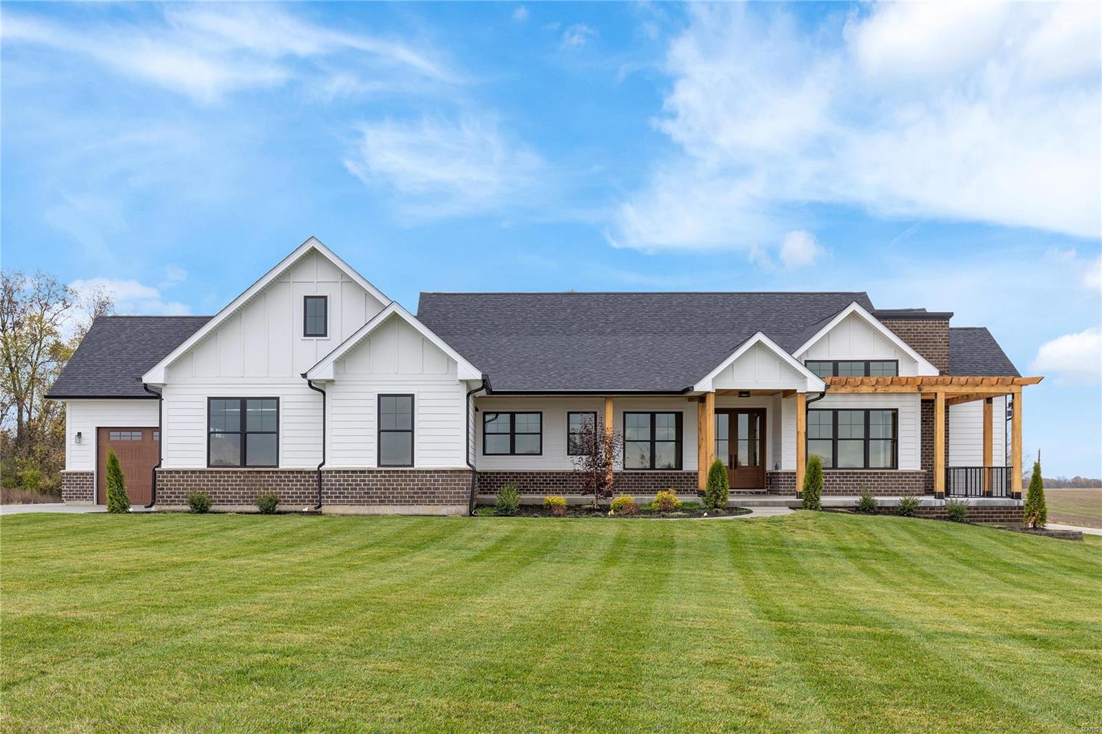 New construction in the newly developed Quail Ridge community. This sensational modern farmhouse features 10’ ceilings, wide plank flooring, designer lighting & expansive windows that offer sweeping views of the surrounding countryside. Wrap around front porch with 8’ double doors with glass panes leads to impressive foyer, vaulted study with sliding glass barn doors and stunning great room with floor-to-ceiling linear fireplace & soaring wall of windows. State-of-the-art kitchen with quartzite countertops, white Shaker cabinetry, Café appliances & 8’ center island adjoins light-filled breakfast room. Spacious primary bedroom suite with 16’ walk-in closet, spa-like bath & access to deck offers an appealing retreat. A 2nd ensuite bedroom completes the main floor living quarters. Lower Level entertainment space includes recreation room & game room plus workout room, 2 additional bedrooms & full bath. Situated on 3+ acre grounds with private outdoor living areas & oversized 3-car garage.
