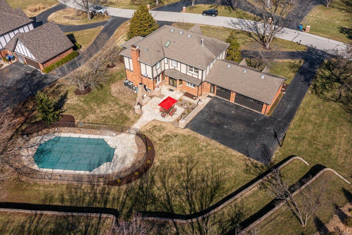 Located in the prestigious Strathmore subdivision of Town & Country, this exceptional Tudor home offers luxury living just minutes from top-rated schools, dining, and shopping. Your outdoor oasis awaits with a saltwater pool & an inviting stone fireplace on the patio—everything your family needs to enjoy the warmer weather ahead. Inside, a grand 2-story entry leads to a freshly painted kitchen that opens to a cozy family room with a fireplace and a charming 3-season room. The finished lower level is an entertainer's dream, complete with a fully equipped bar featuring an ice maker, dishwasher, microwave, & refrigerator—plus a beautifully finished full bath for added convenience. Additional highlights include a spacious 3-car garage, an irrigation system, a security system, custom millwork & thoughtfully designed outdoor lighting to enhance the home's charm and security. This home offers everything you need for comfortable living & memorable entertaining. Additional Rooms: Mud Room, Sun Room