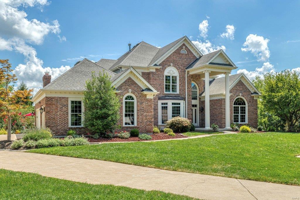 Beautifully designed brick 1.5 Sty on premium 1.7-ac lot. 2-Sty marble foyer leads to private study with built-in work center, coffered dining room & stunning great room with architectural columns, marble fireplace flanked by built-in bookcases, wet bar & 2-sty wall of windows with unsurpassed views. Designer kitchen with quartzite countertops, 42” cherry cabinetry, butler’s pantry & planning center adjoins breakfast room framed by arched entryways & vaulted hearth room with fireplace. Spacious master bedroom suite with luxury bath with walk-in shower offers an appealing retreat. T-staircase accesses 3 additional bedrooms, 1 with ensuite bath & 2 with Jack n’ Jill bath, & loft sitting area. Lower Level includes recreation room with floor-to-ceiling stone fireplace & entertainment center, billiards room & 2nd kitchen plus workout room, 5th bedroom & 1 ½ baths. French doors open to outdoor living area with wrap around deck, covered patio & free form pool surrounded by landscaped gardens. Additional Rooms: Wine Cellar