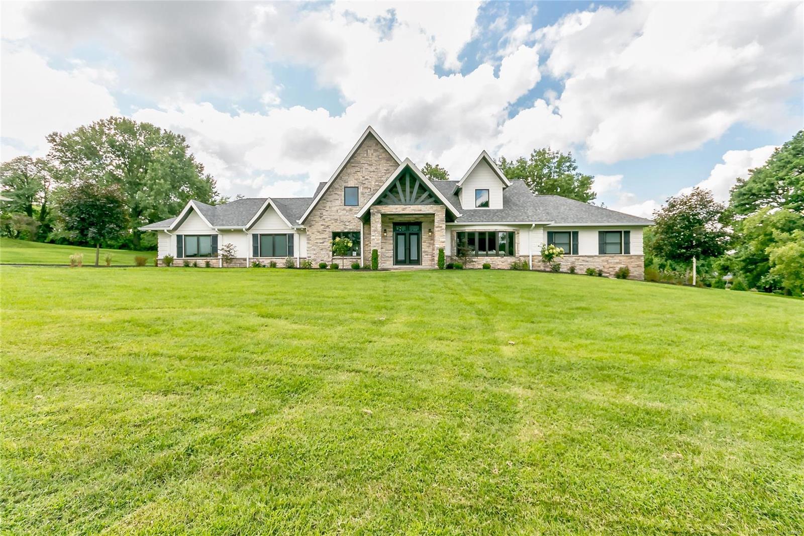 Renovated to Perfection! This 1.5 Story Home is the epitome of Gracious Living! A Glorious, Two Story Staircase graces the Entry that opens to a visual Storybook Classic Home that is designed for effortless entertaining/unparalleled luxury living! A home that’s perfectly positioned in “Chapel Hill”, a prestigious community in Town & Country! Elegantly flanking the Entry is the Living Room/Formal Dining Rooms & leads to Hearth Room & the State-of-the-Art Kitchen w/ Dacor Stainless Appl, Custom Cabinetry/Counters that opens to a Brfst Rm & Hearth Room that focuses on a beautiful Fireplace. Main Flr includes Mstr Bedrm Suite W/ Tray Ceiling, Custom Ensuite Lux Bath & custom Closets! Powder Rm & MFL! Upper Floor has 2nd Mstr Bedrm Suite w/ Lux Bath, 2 large Bedrooms & Hall Bath! Fin LL is a complete Living Apt w/ Full Kit & Bath, 2nd Ldry Rm & private entrance! The 1 Acre lot is a park-like setting; perfect for an Inground Pool & the Covered Patio is the ideal setting for Outdoor Living!