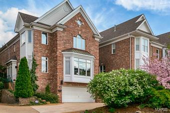 Blocks from downtown Clayton, this classic side entry brick home with contemporary flair is sure to please!  The marbled entry greets you in style and the step down great room invites you to stay with its framed garden views, cozy fireplace and display niches. French doors open to a light filled den with two walls of windows and a built-in library.  Tray and coffered ceilings throughout provide architectural interest and ambient lighting.  The kitchen and hearth room are an entertainer’s delight with a SubZero fridge, double ovens, wine cooler, center island w/ veggie sink and breakfast room. Glass doors lead you to perennial gardens and a spacious deck.  Upstairs are a workstation/sitting room and 3 en suite bedrooms, including a gracious master suite with fireplace and a phenomenal walk in closet!  Additionally, there is a media room, wet bar and full bathroom in the lower level.  A show room 3-car tandem garage completes the package with a shop sink and abundance of storage.