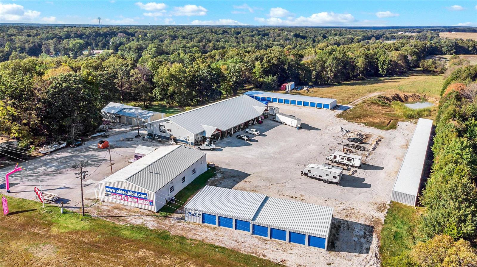 ENDLESS OPPORTUNITY RIGHT HERE!! AWESOME LOCATION!Take advantage of this High Visibility 19++ Acre property w/ a TON of improvements!Currently used as Auction House,(Jackie O's)-The 8400 sq ft, AMISH Built Building w/ Handicap bathrooms, Full kit, Office, dressing rooms, concrete flr, electric, 12' Garage dr & full HVAC!Additionally, a 70X40 Multi-purpose Commercial build.,previously a church, & then a resale store,& A 48X30 pole & metal structure unattached garage/shop building w/ 2 roll-up doors, concrete flr & electric.Lastly,(3) sets of storage units, 30X18=18units, double deep, 220X15=25 units,& 140X30!Truly, a Beautiful piece of land, approximately 1/2 woods (with pond) & 1/2 pasture land.There is a deep well, septic, & asphalt as well as gravel parking lots. Manufactured Home is on public water.  CALL listing agent for your Private showing today- LAND, Improvements, & possibly inventory is for sale- NOT the Biz itself. All leases w/ the rental units will go to the new owners. Location: High Traffic, Hwy/Interstate Frntg, Other, Rural