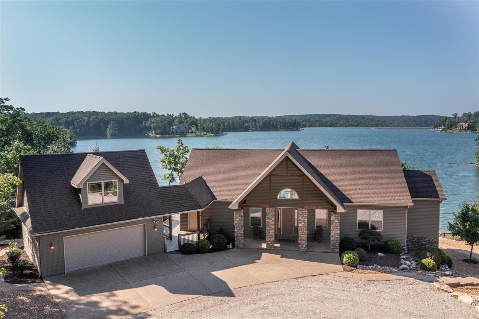 Welcome home to this stunning, waterfront home perched on the shoreline of 236 Acre Alpine Lake in the desired gated Innsbrook community. Hidden between towering oaks and Midwestern foliage on the 1.8 acre lot, this rare find features 250+ feet of shoreline, two separate leveled walkways to the water’s edge, and a collage of elongated windows providing elevated lakefront views throughout every square inch. Soak up outdoor leisure with a fire pit area, private dock, patio, and expansive deck. Luxury living continues indoors with the main level open floor plan, enhanced with vaulted ceilings, large dining and kitchen area, and an expansive center island that are sure to impress. The walk-out lower level is an entertainers dream – including 2 full baths, 3 guest bedrooms, storage room, and a spacious living area. All furniture included, a true turn-key purchase. A completely private setting, breathtaking views, and architectural details perfectly form the home you’ve been seeking! Additional Rooms: Mud Room
