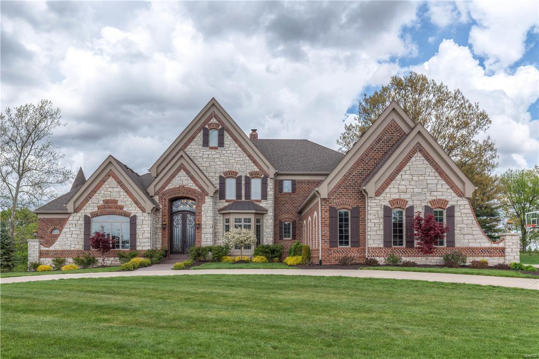 Wildwood luxury living at it’s finest. This custom built 1.5 story home is meticulous and upgraded in every facet. Curb appeal abounds from this stately home welcoming you in to the open floor plan with soaring ceilings, detailed millwork and gleaming hardwoods. The main floor offers an executive office, formal dining and spacious living room with hand hewn ceiling beams. The two story hearth room with see thru stone fireplace surrounded by built ins opens to the expansive gourmet kitchen and light filled breakfast room. Relaxing main floor master suite invites you into the luxurious master bath and oversized walk in closet. The second floor provides four addl. large bedrooms and three full baths. The lower level is perfect for entertaining with a family room, gaming area, full bath and well equipped wet bar. 4 car garage, main floor laundry, surround sound…the list is endless. Situated on three gorgeous acres in a prime West County location. Rockwood Schools. Your dream home awaits! Additional Rooms: Mud Room