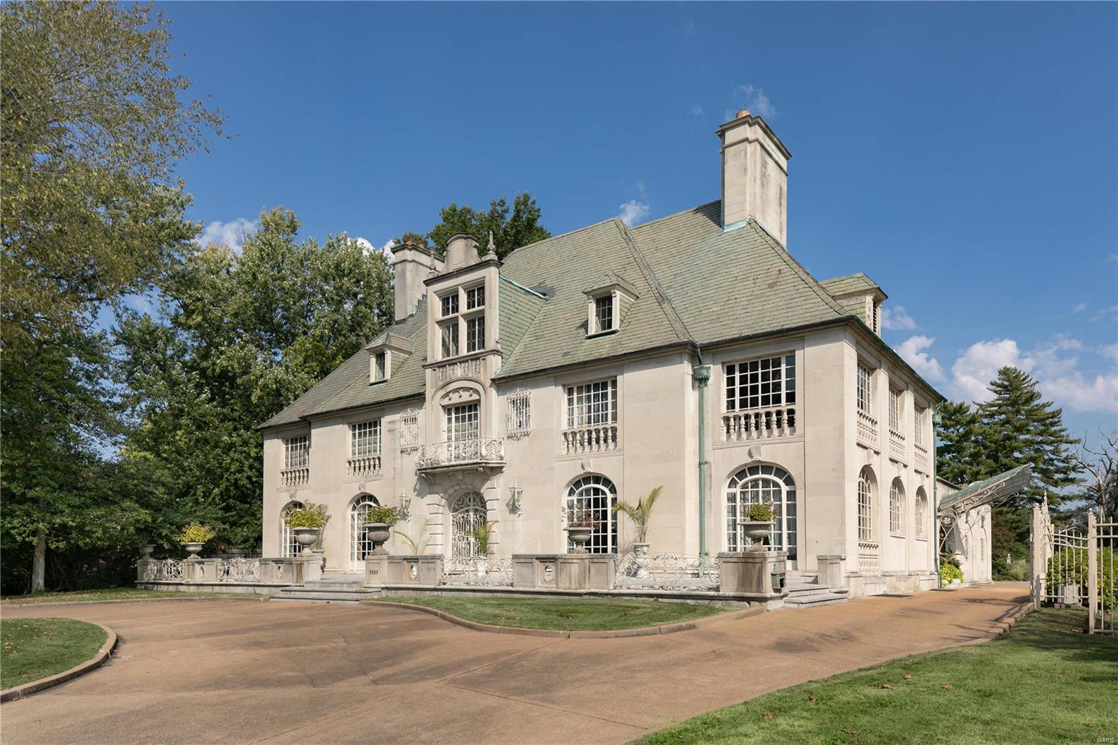 Beautifully situated on a two-plus acre lot directly across from Forest Park and considered to be one of the finest homes on Lindell Boulevard, this striking French-style residence features remarkable architectural detailing including a cut stone façade, graceful exterior ironwork and a rare glass side-entrance marquee. The elegant interior includes a graceful marble staircase with delicate wrought iron railing, beautiful marble and terrazzo floors, paneled walls, rare hand-carved marble fireplace mantels, and exquisite decorative plasterwork moldings and ceiling medallions. Multiple French doors create a light interior that opens to a private rear garden and pool area creating the perfect space for relaxing and entertaining. The finished lower level includes additional entertaining space which includes a bowling alley. This is an exceptional historic home. Additional Rooms: Sun Room
