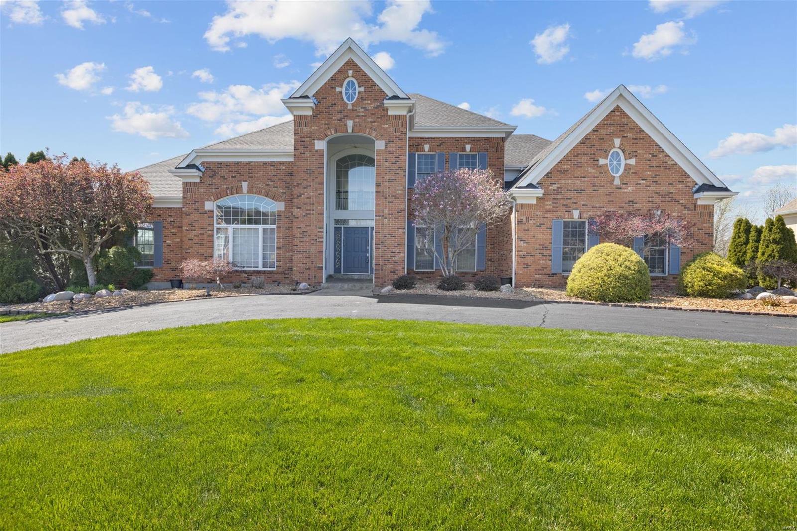 Welcome Home! This stunning 5 bedroom home exudes luxury. A grand foyer with sweeping 2 story ceilings greet you. The marble hearth, 2 story windows flanking the back wall, & wet bar are touches of elegance that lead into the kitchen, which boasts high-end stainless steel appliances, two dishwashers, long stretches of granite countertops, a walk in pantry, massive island & wine cooler. A breakfast nook & separate dining room make entertaining a breeze. The main floor primary suite is truly an oasis, with a regal tub & envy worthy walk-in closets. The upstairs features three additional large bedrooms, all with ensuite bathrooms. The finished walk out basement is perfect for parties with a huge rec room, additional bathrooms/bedroom, a bar, a kitchen, & plenty of living space & storage. Sun yourself by the private, in-ground pool (one of the few in the subdivision), throw incredible BBQs on the deck overlooking the sprawling backyard which backs to common ground. Oversized 3 car garage!