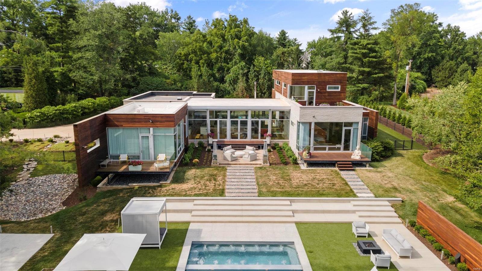 Privacy and luxury abound in this magnificent modern masterpiece. Wall of windows facing the grounds, gorgeous floors & 10+ft ceilings welcome you to this stunning compound. The kitchen, dining, & great room offer impressive views of the new pool/spa & guest house, along with both front and back patios, the ultimate in indoor & outdoor living. The kitchen & butler's pantry are incredible in design and functionality. The primary suite is a serene space with expansive closets, bath, & private deck overlooking the 1.9 acreage. Also on the main floor is a guest room that doubles as a family room. Upstairs are 2 bdrms, 2 baths & a den with built in desks, & a lovely deck. The lower level offers a gym, bath & recreation room you can design to suit your needs. Wow guests with a pool house with chef's kitchen, 2 ensuite bdrms, pool bath, family room, & game room. The main house offers 5700+ square feet while the pool house offers 1700+ - luxurious everyday living in a unique, special getaway. Additional Rooms: Mud Room