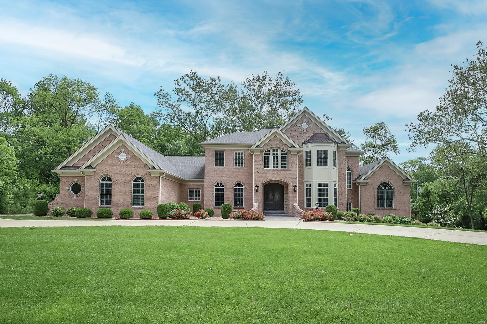Spectacular, energy efficient (zoned geo-thermal HVAC) custom-built home featuring 6 Bedrooms, 7 Baths (5F/2H) with nearly 9,000 sqft of living space and is situated on a very private 1.28-acre lot, in the heart of Frontenac! Open floor plan, including Study/Office with custom built-ins, elegant formal Dining Room & gorgeous Great Room with box-beam ceiling, WB fireplace, custom built-ins, and a wall of windows. Professionally finished, walk-out Lower Level has over 2,600 sqft with huge Rec Room, gas fireplace, custom wet bar, Wine Room, Exercise Room, Game Room, Media Room with 3-tiered seating; walk-in sauna, 5th & 6th Beds & 5th full Bath. Highlights: 10’ plus ceilings, gorgeous Asian Walnut hardwood flooring, extensive millwork/moldings, alarm, irrigation systems, Beam vacuum system, circular drive driveway & oversized, 3-car garage. Relax outside on stamped concrete patio with built-in BBQ grill, outside fireplace and patio under the pergola! Perfect for entertaining! Additional Rooms: Mud Room