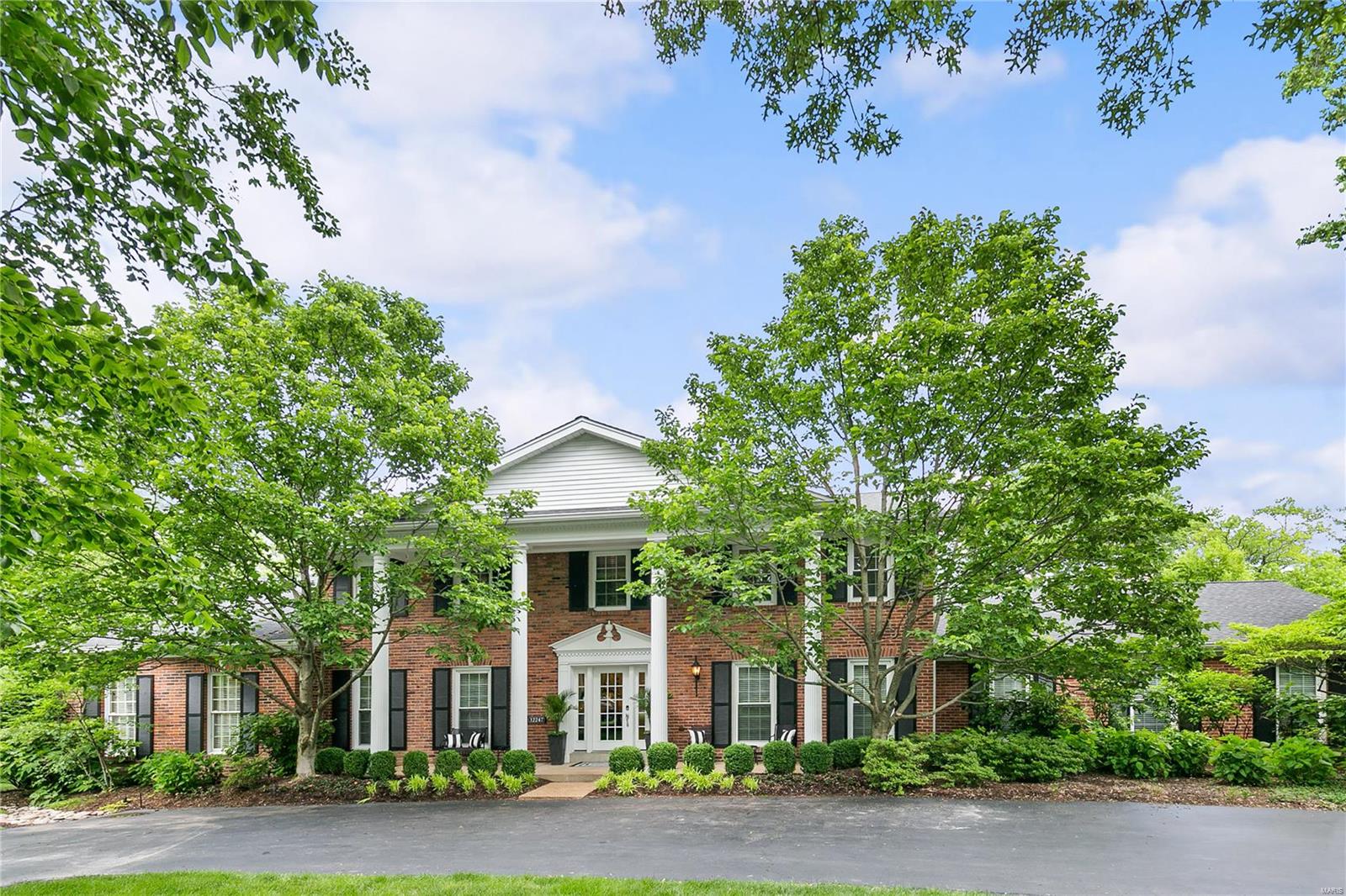 This incredible brick colonial home is impressive from the manicured grounds to the quality interior. Enter the grand foyer w/ rich hardwood floors that span much of the main level. Stunning large-paned windows throughout allow sunlight to fill the many rooms. Adjacent to the formal DR is a chefs dream kitchen. Boasting opulent granite counter-tops, large island w/ seating for 4, custom cabinetry, top of the line appliances, & walk-in pantry w/ beverage fridge. Breakfast room w/ access to pool and large deck/patio area. Mudroom w/ pool bath opposite from the private study. Kitchen opens to hearth room w/ FP. Light-filled FR has vaulted ceilings & beams adjoining LR. An exquisite 1st-floor master w/ panoramic views boasts a luxury bath w/ double vanities, jetted tub and steam shower. Upstairs has 3 additional bedrooms that share hall bath and 1 bedroom suite. A walk out finished LL with wine cellar, game room,and gym adds to the grandeur of this home. Pebble Tec pool, 3 car garage Additional Rooms: Mud Room, Wine Cellar