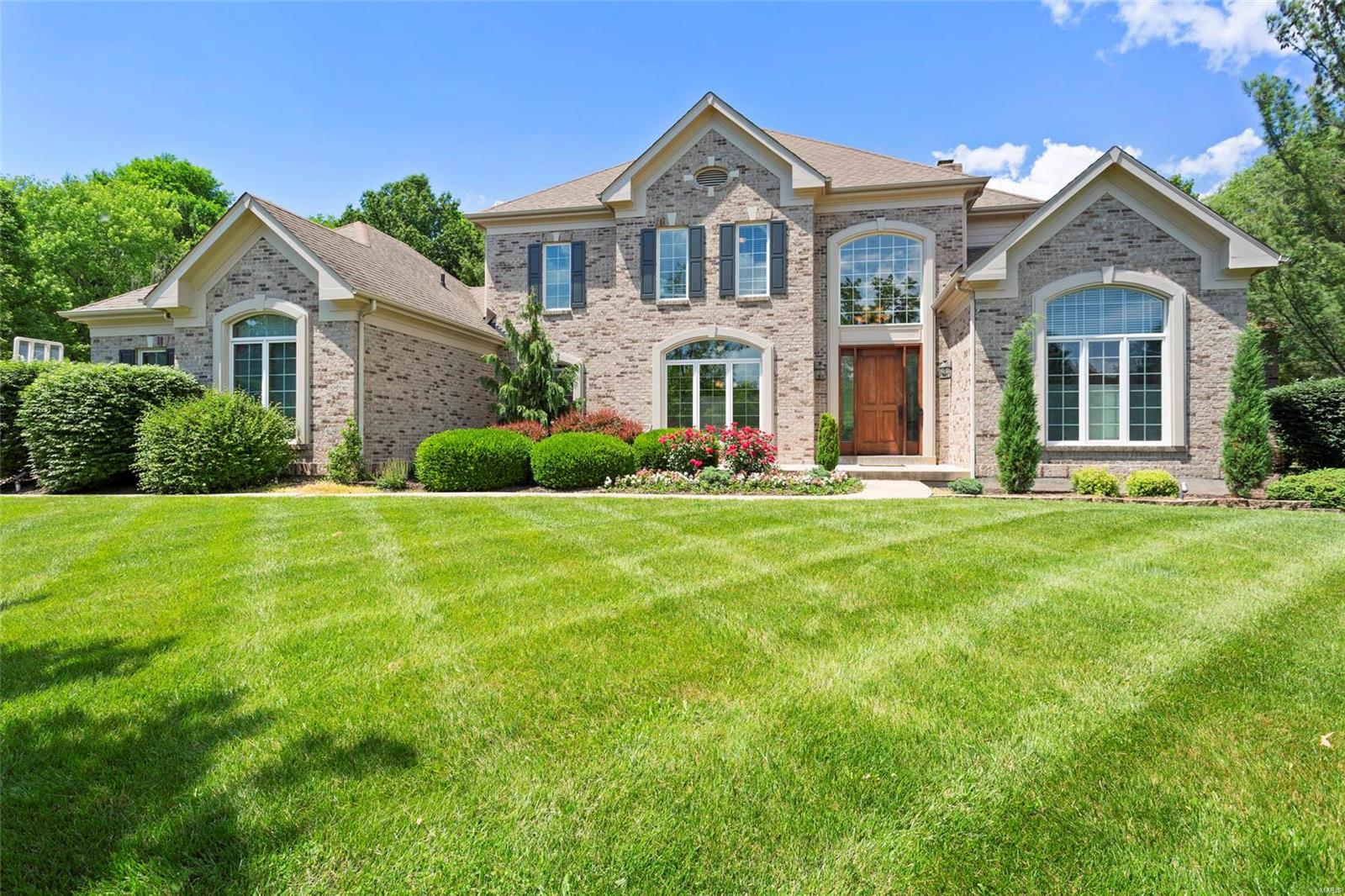 Wow! Stately 1.5 story on a private acre lot at the end of a quiet cul-de-sac in desired Greystone Subdivision. This four bedroom (potential 5th in lower level), four full, two half bath property has custom finishes throughout! Gleaming wood floors, gourmet eat in kitchen with breakfast bar, custom cabinetry, granite counters, stone island and stainless appliances. Vaulted hearth room, main floor office/den, formal dining, two story great room with fireplace and built ins, wet bar and main floor master with coffered ceiling, his/hers closets and luxury ensuite bath. Upstairs find a loft space with three spacious bedrooms, two baths and a study area. Finished lower level with home gym, second wet bar area, game room, wine closet, media room, addl. sleeping area and full bath. Backyard oasis made for entertaining has a pergola covered patio with cooking station, free form inground pool with stone waterfall and spa. 3 car garage, main floor laundry. Award Winning Rockwood School District.