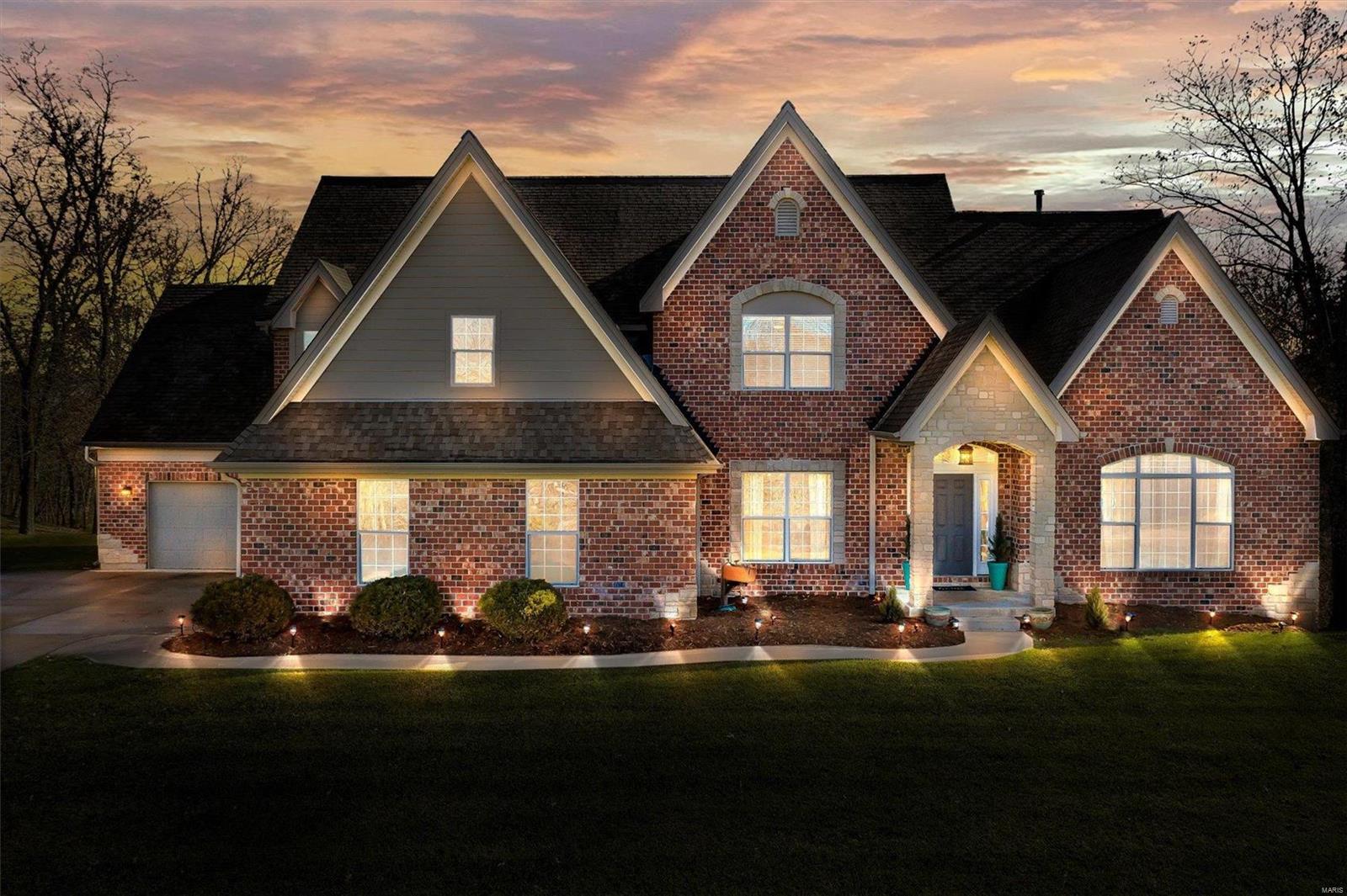 Why wait for new construction when the home of your dreams is ready NOW. Gorgeous 1.5 story estate sits on 3 acres of beautiful yard surrounded by trees, offers over 5,200 sq ft of living area, & is built to impress. Main floor features hardwood flooring, 9 ft doors, remodeled kitchen, hearth room, breakfast room, formal dining room, & 2 story great room. Main floor Owners Suite is incredible has a massive walk-in closet, separate tub & shower, & dual vanities. Upper level has a loft, 3 large bedrooms, one en-suite & a Jack N Jill bath. Walk out lower level has 5th large bedroom, full bath, family room/rec room with fireplace, wet bar, a gym which could easily be used as bedroom #6 or an office, & 2 storage areas. Home has an oversize 2 car & oversize 1 car garage.  Brand New carpet just installed & freshly painted interior. Stylish new light fixtures. Stunning w/ 3 gas fireplaces, tankless hot water heater, & EXTENSIVE crown molding, ELECTRIC CAR CHARGING STATION IN GARAGE